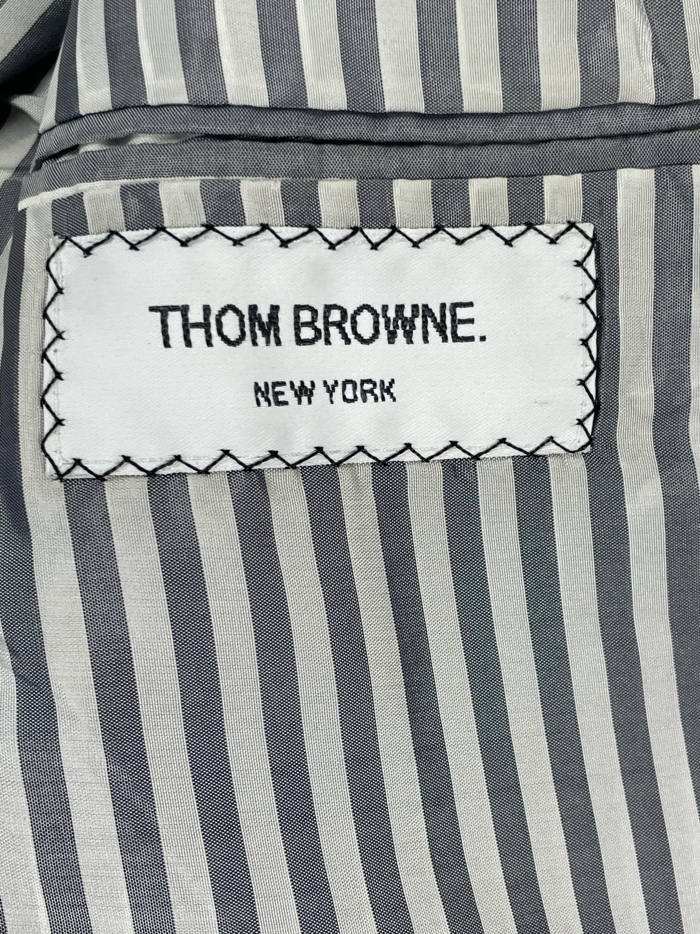 Thom Browne New York woven brand label on striped lining