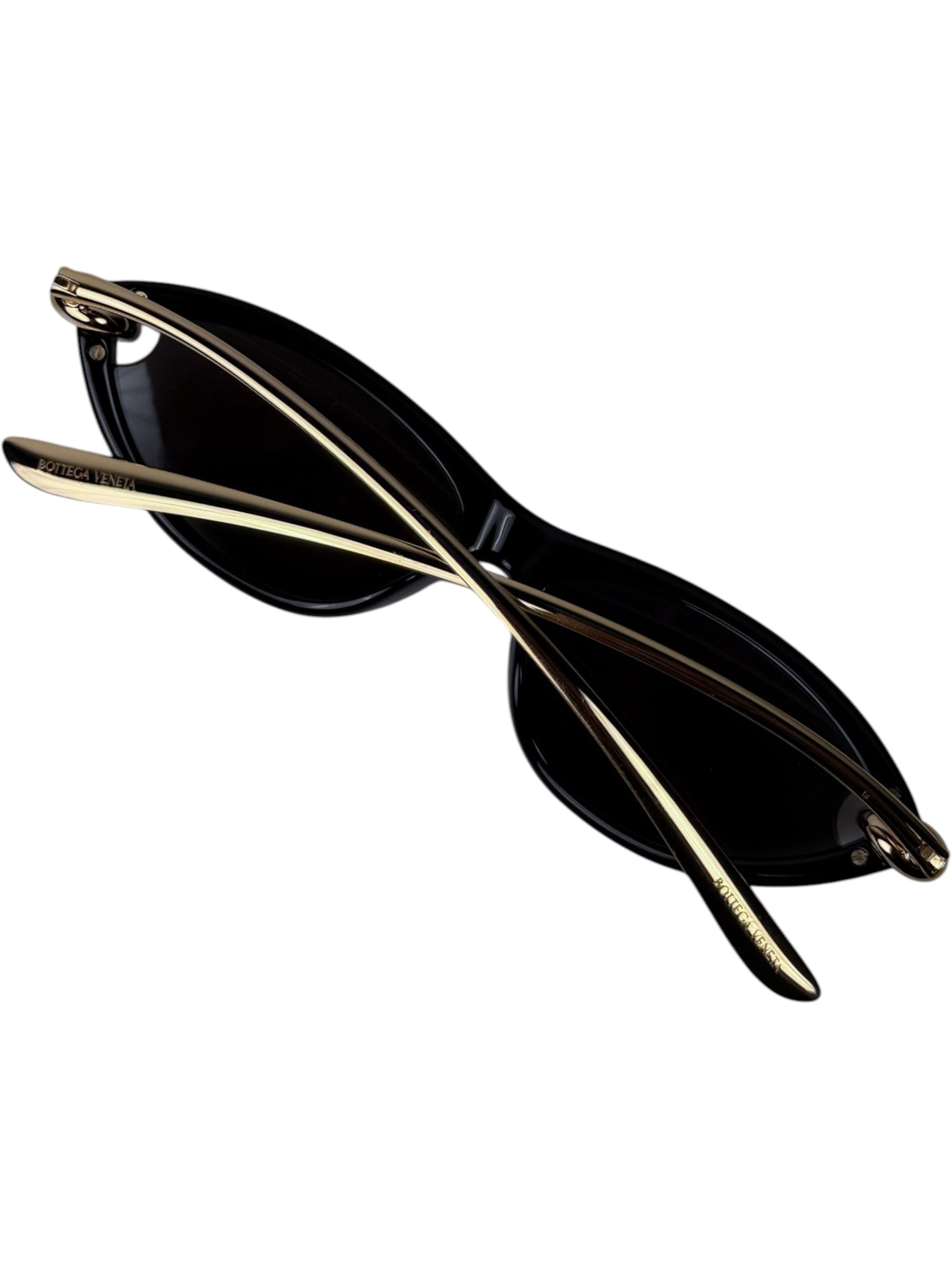 Folded Bottega Veneta Knot black cat eye sunglasses with gold temples