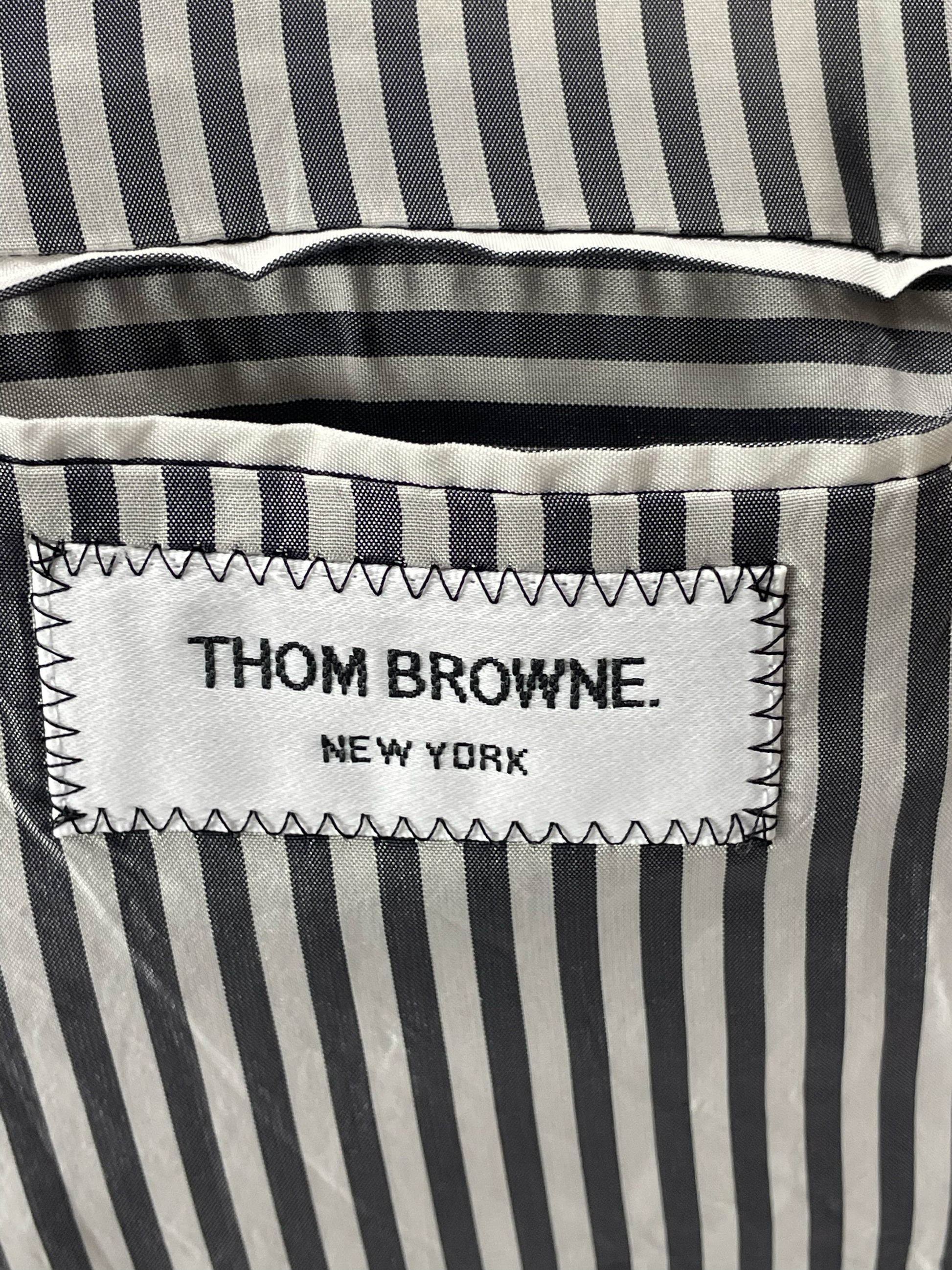 Thom Browne New York label on striped lining of grey blazer