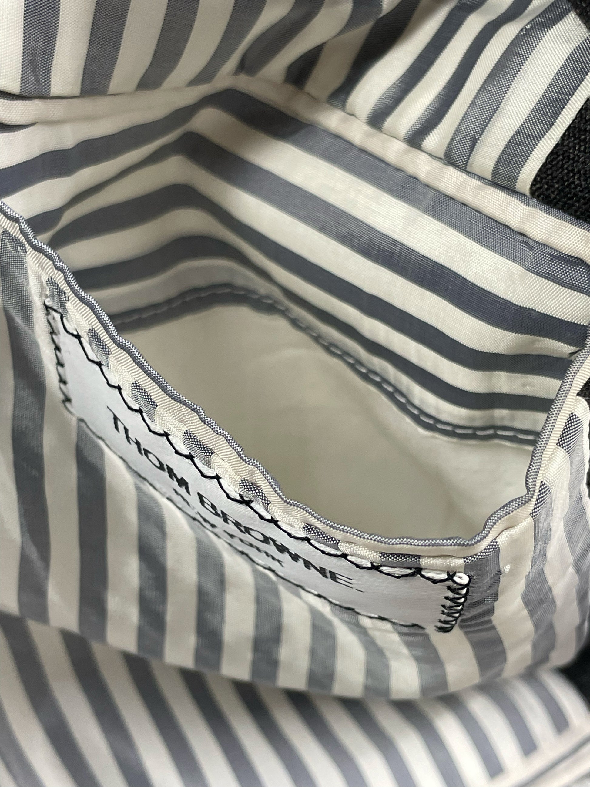 Grey and white striped lining pocket on Thom Browne wool blazer
