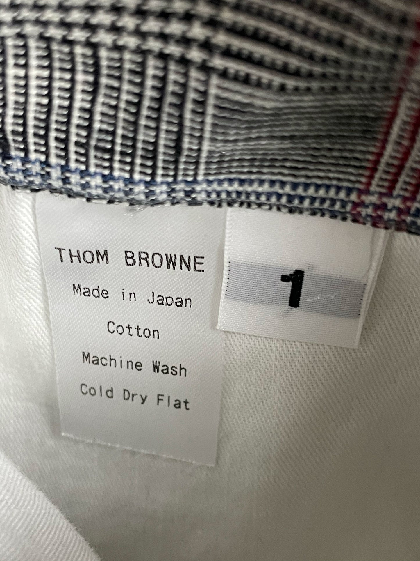 White rubber buttons and RWB grosgrain on Thom Browne seersucker jacket