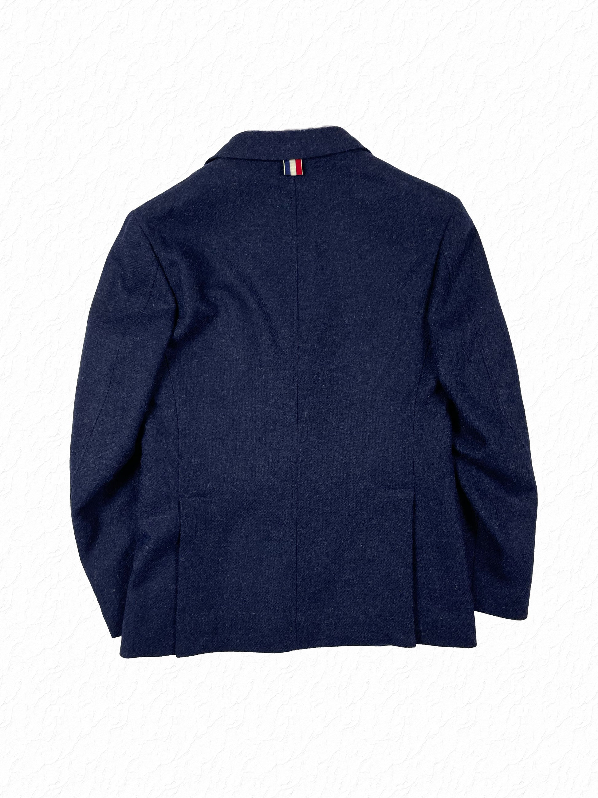 Signature red white blue grosgrain loop on Thom Browne tweed blazer