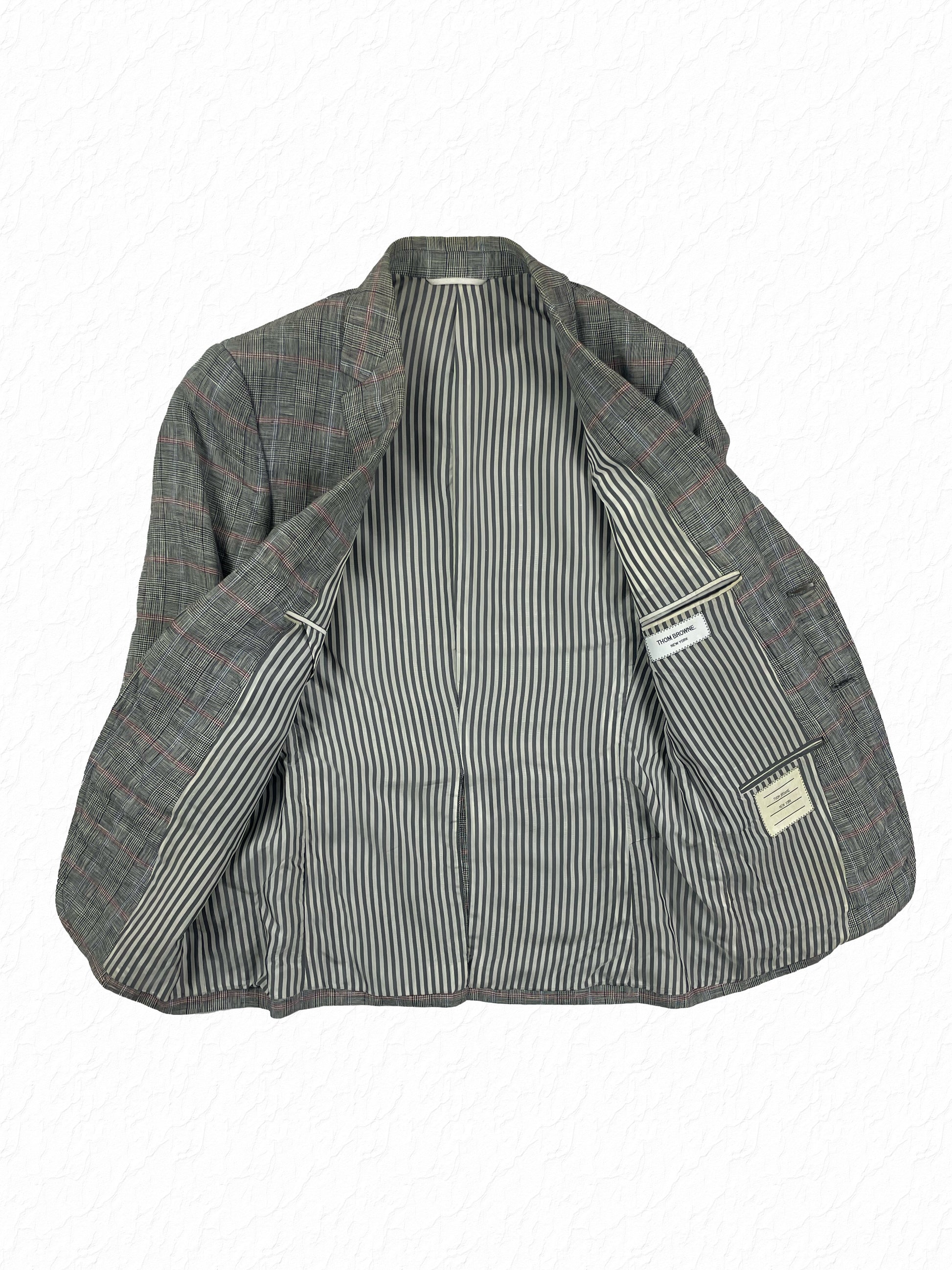 Signature grey and white striped lining on Thom Browne linen blazer