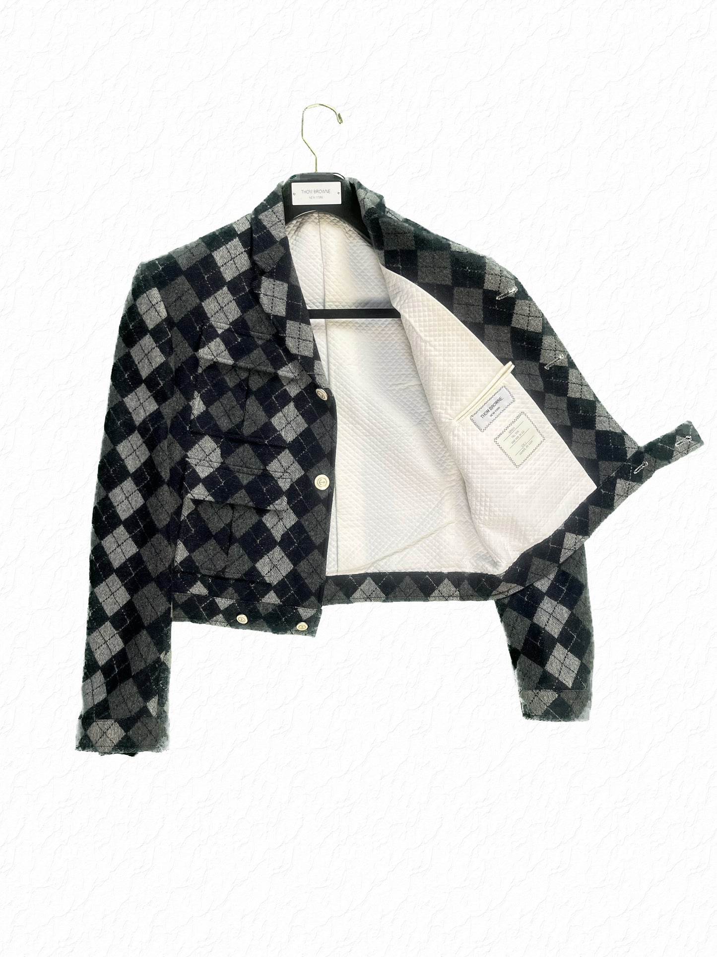 Grey and navy argyle cashmere Thom Browne cropped jacket with quilted cream lining