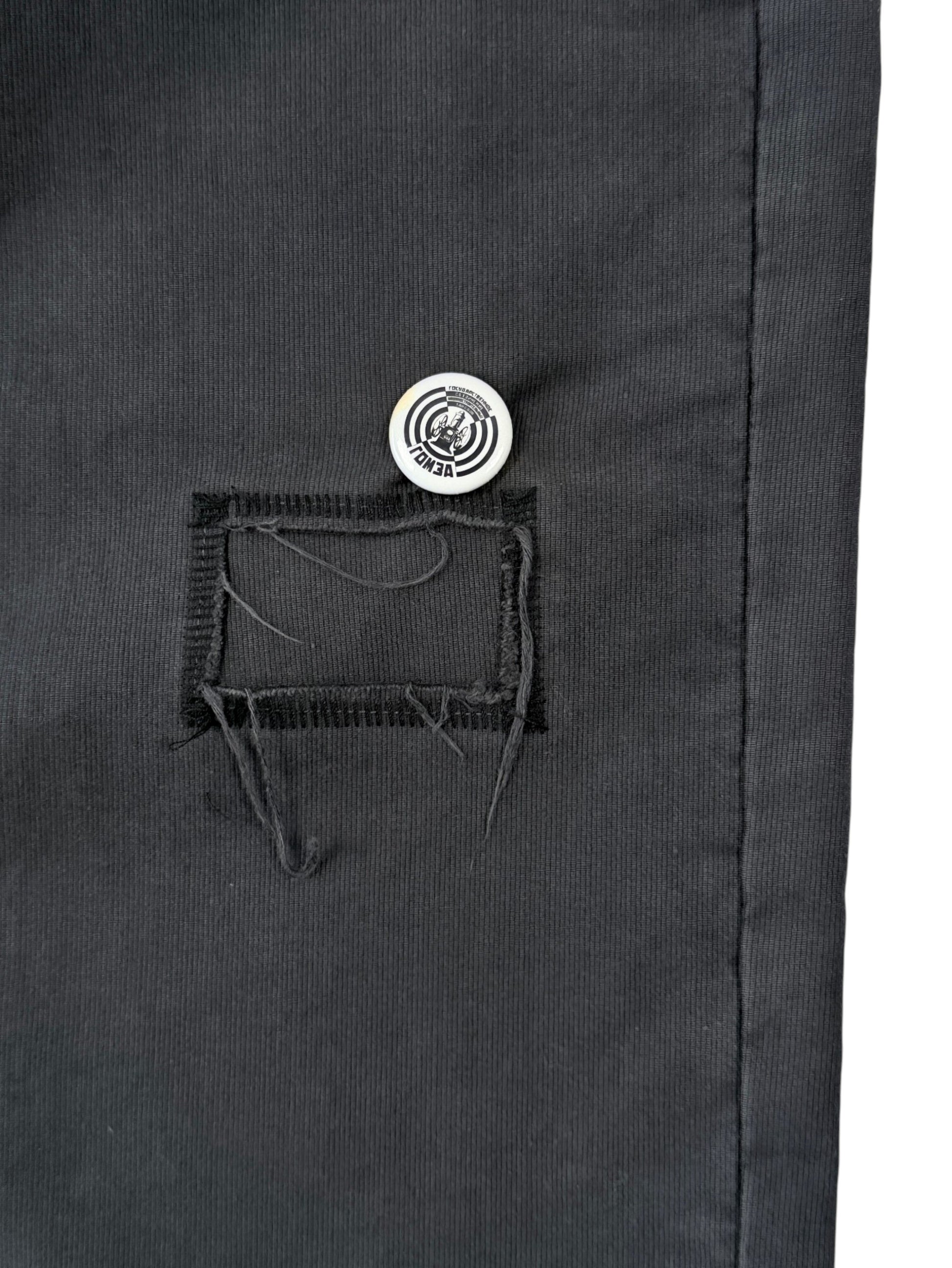 Distressed patch pocket with white pin badge on ERD Swiss Auto Dicky pants