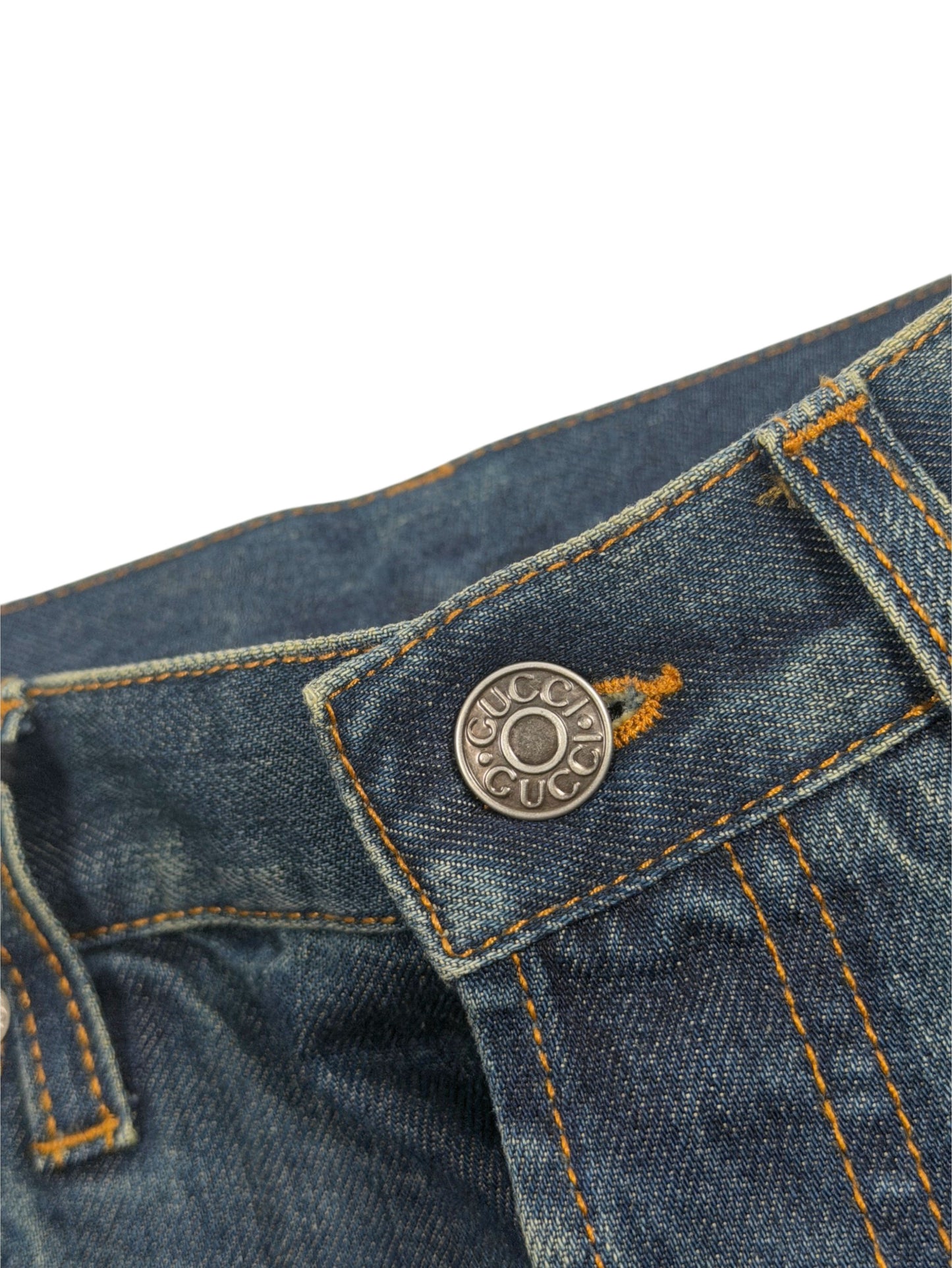 Gucci logo shank button on blue vintage wash jeans