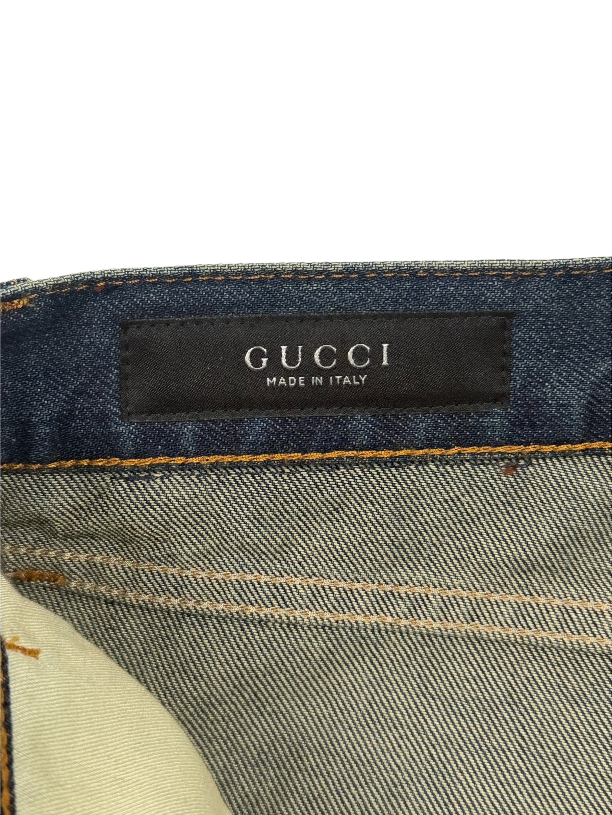 Gucci woven brand label on vintage wash cotton denim jeans