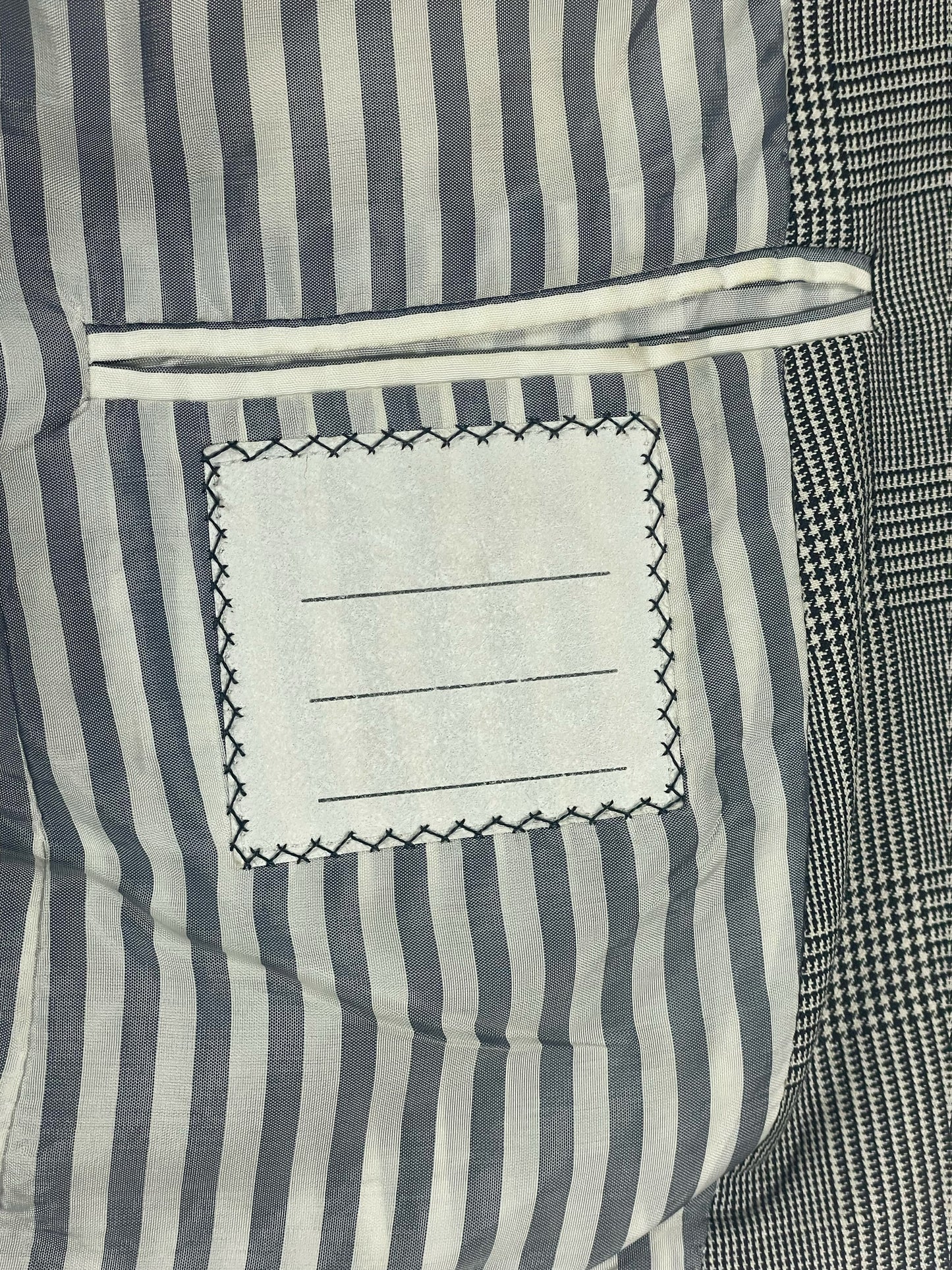 Signature RWB grosgrain trim on Thom Browne glen plaid blazer