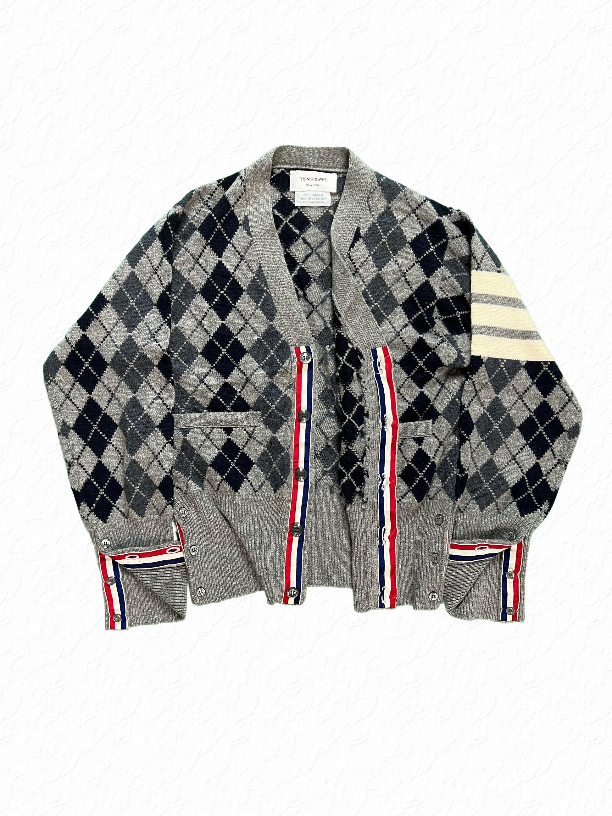 Red white and blue grosgrain placket on Thom Browne argyle cardigan