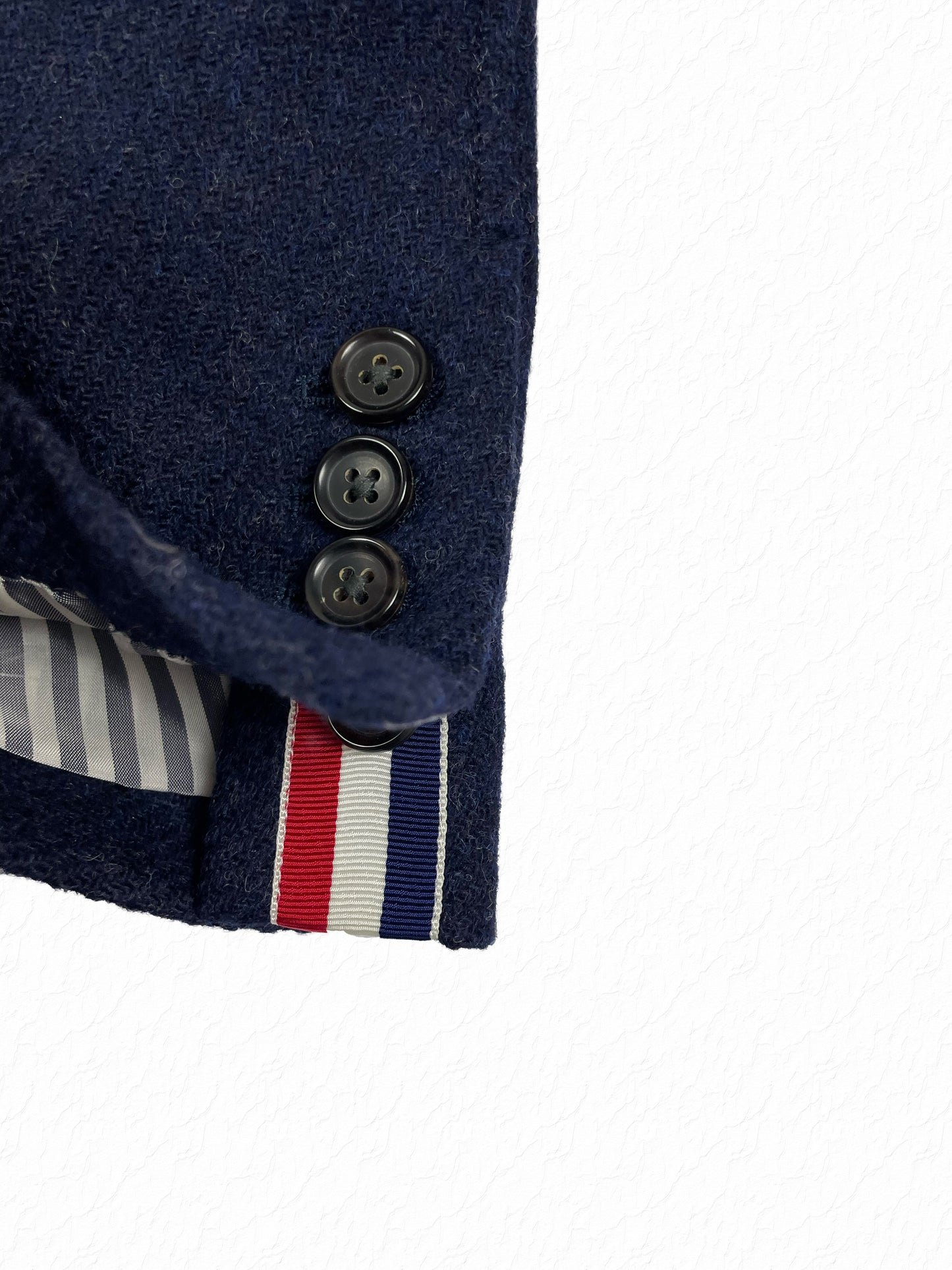Wool tweed Thom Browne blazer with functional cuff buttons and grosgrain tab