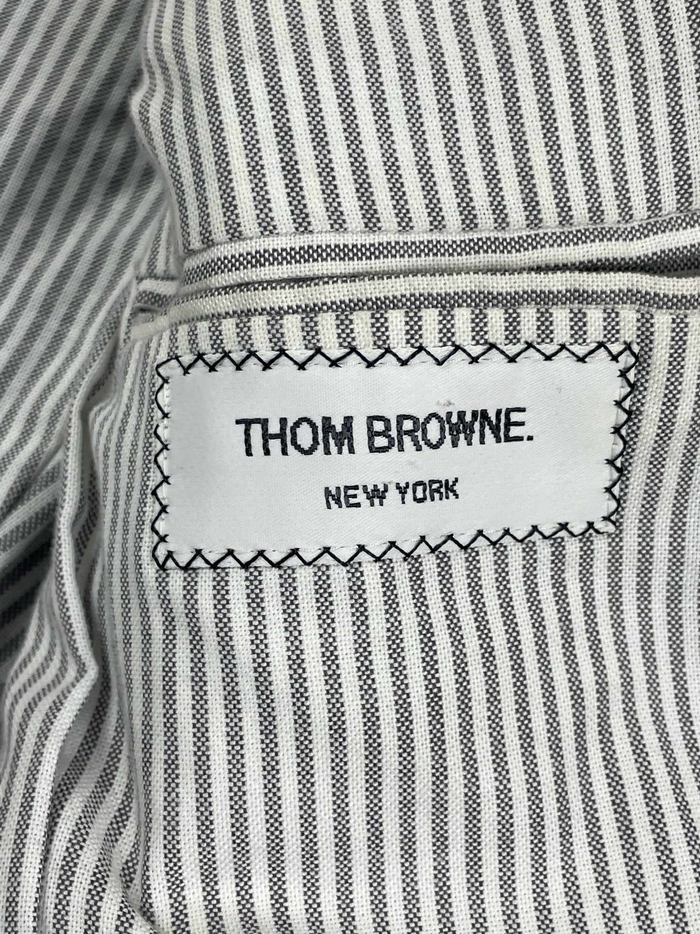 Thom Browne New York label on grey cashmere rib knit jacket