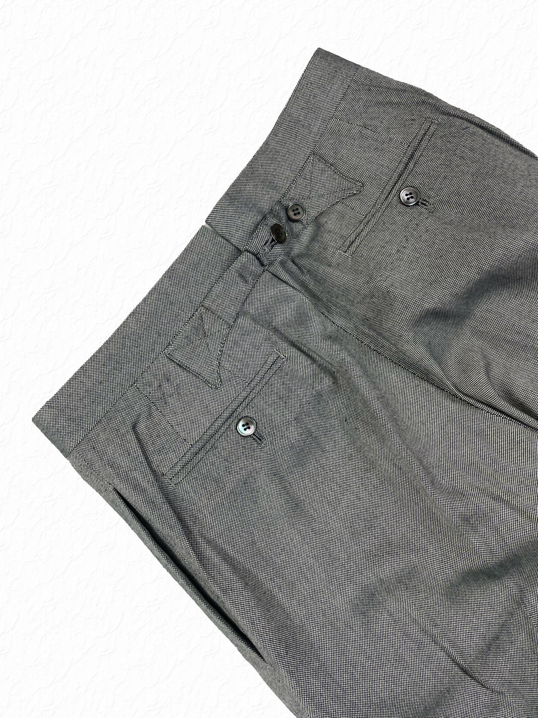 Buttoned welt pockets on Thom Browne salt and pepper cotton trousers