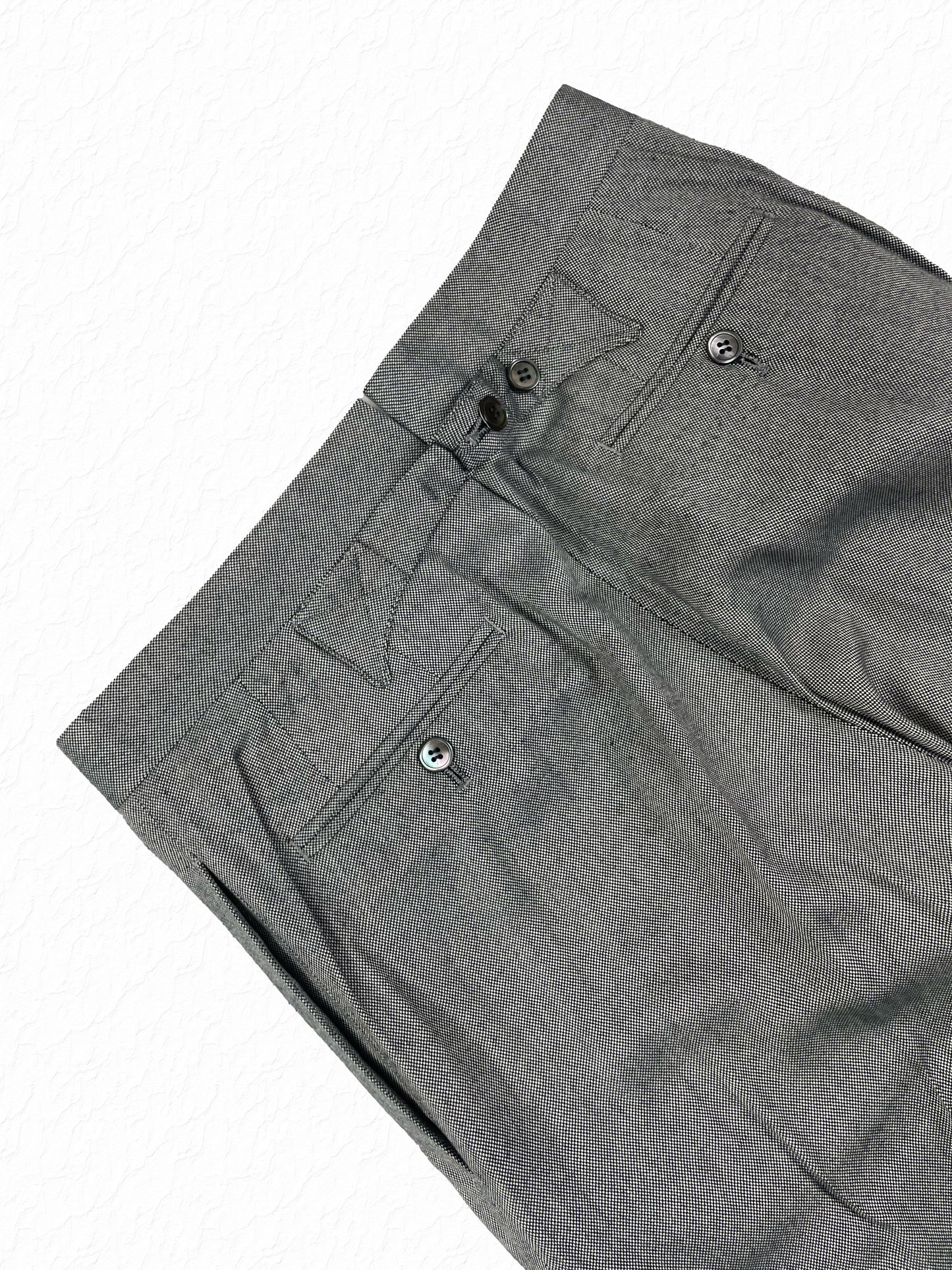 Buttoned welt pockets on Thom Browne salt and pepper cotton trousers
