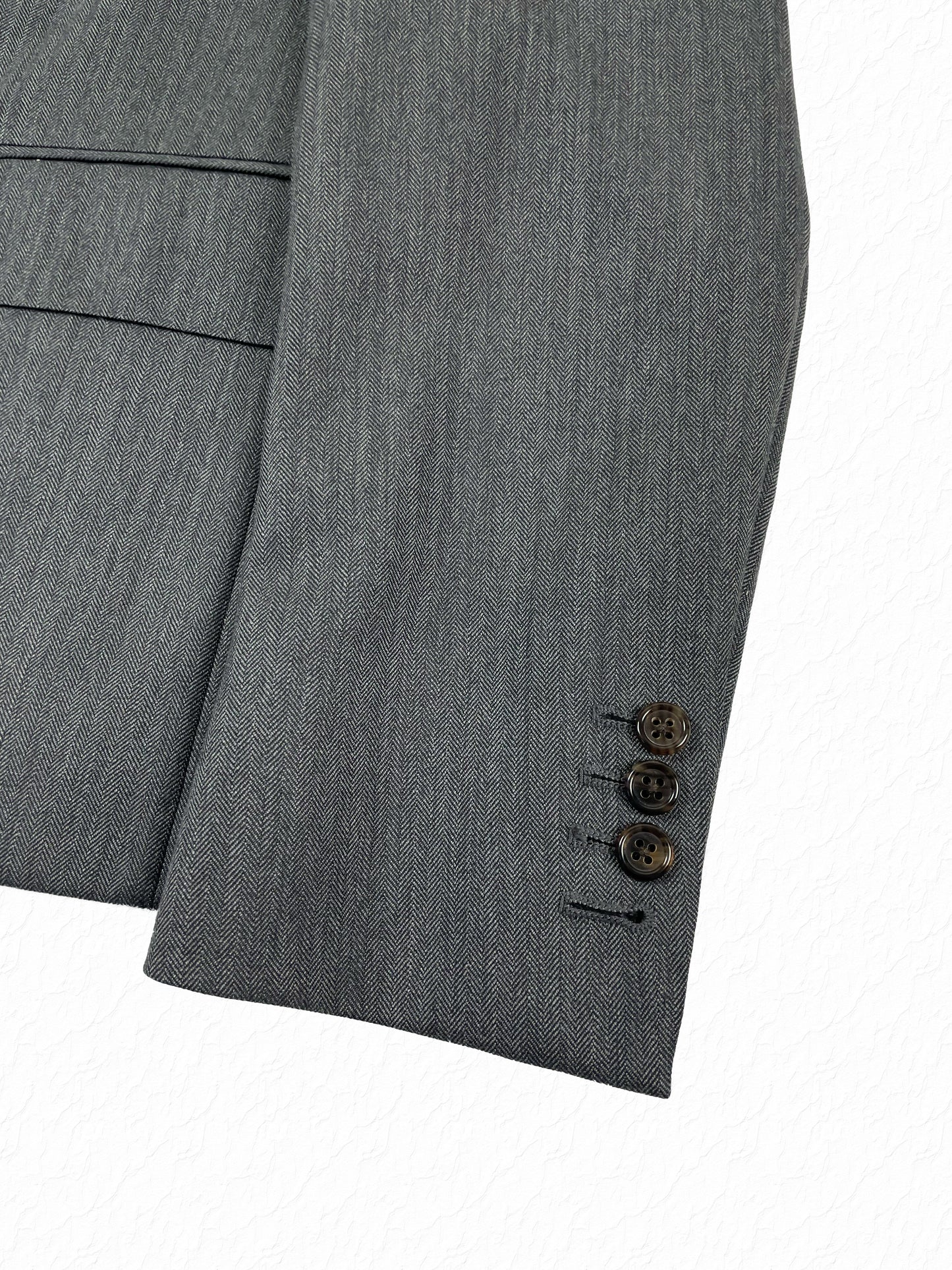 Herringbone wool cuff buttons on Thom Browne Boy Cut blazer