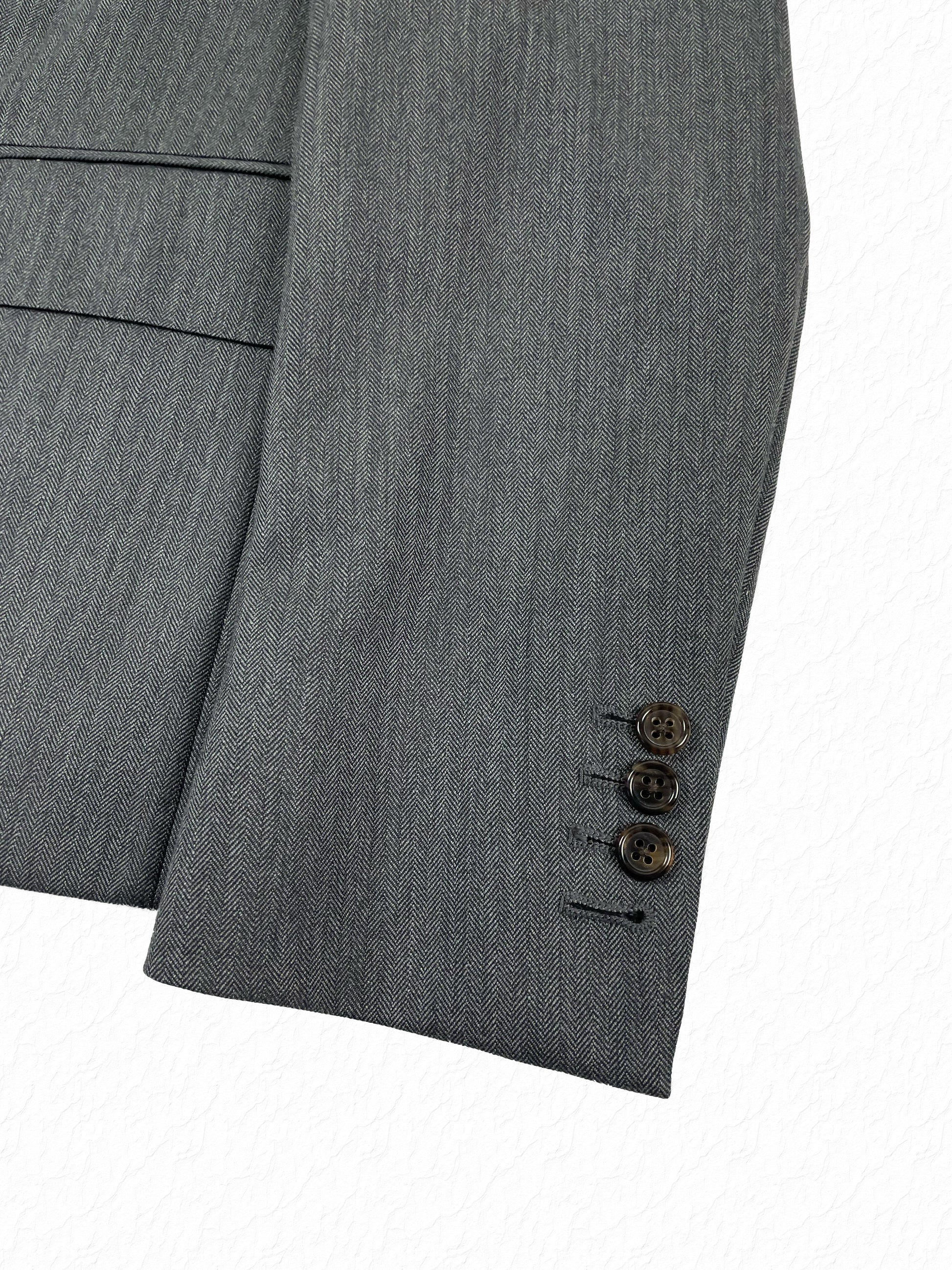 Herringbone wool cuff buttons on Thom Browne Boy Cut blazer