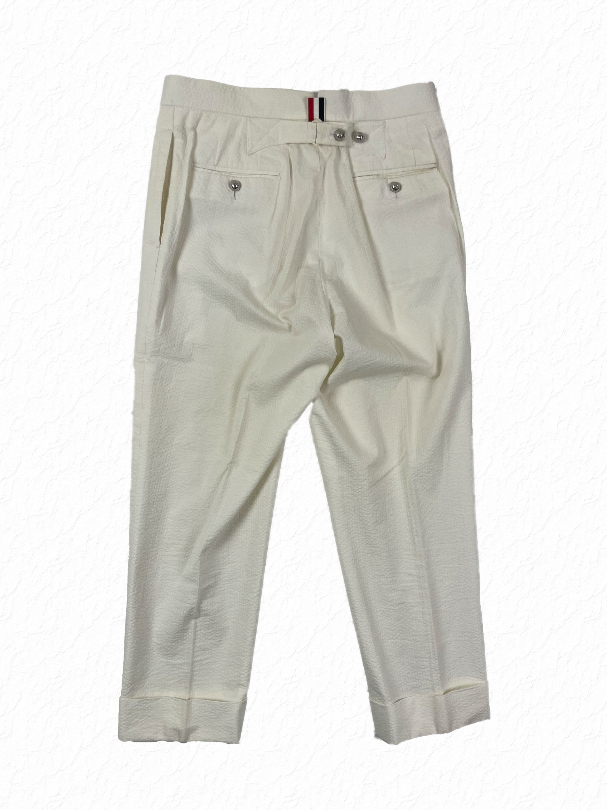 Seersucker cotton tailored trousers with silver button pockets by Thom Browne