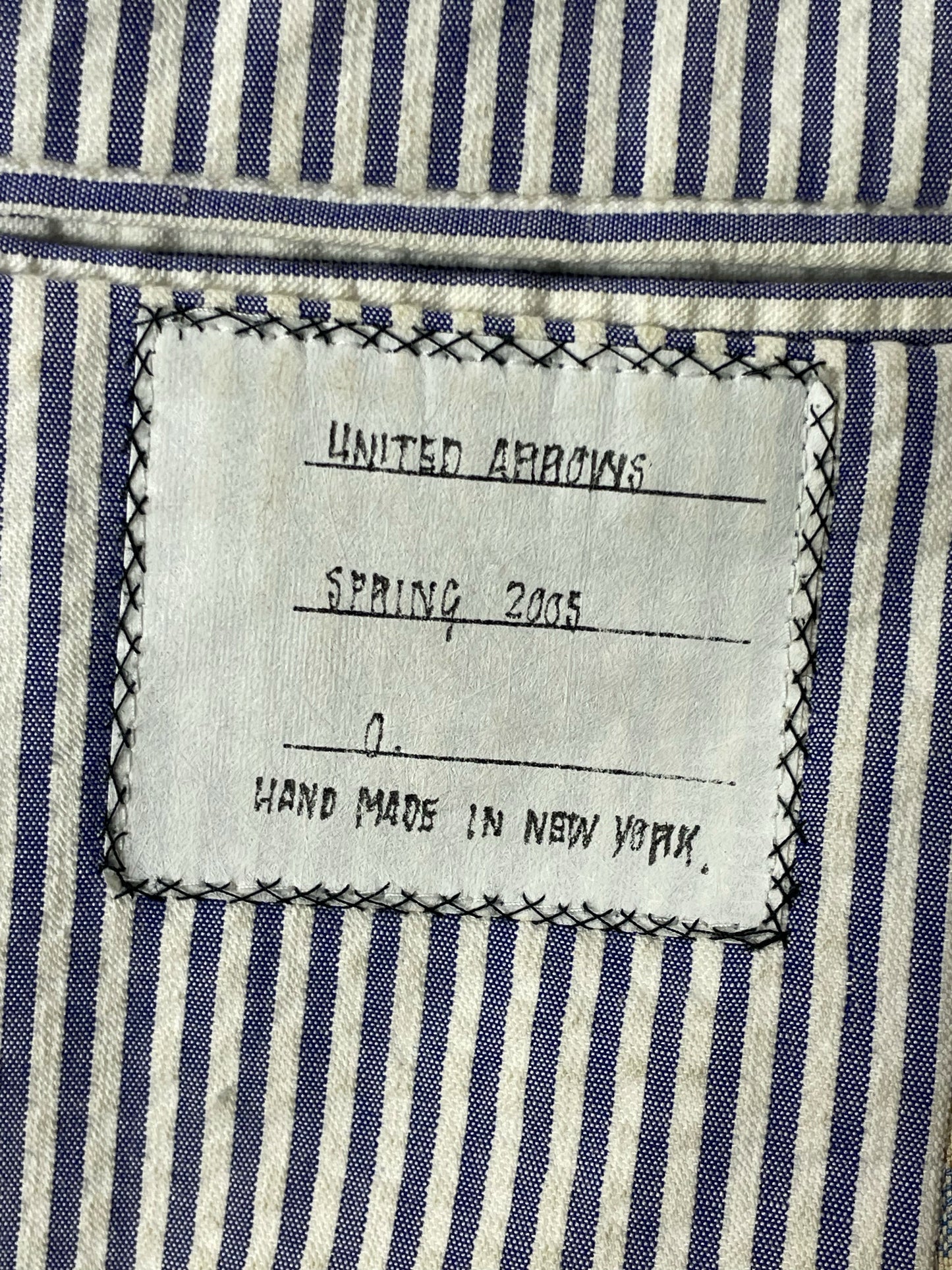 Blue seersucker striped lining of Thom Browne plaid wool sport coat