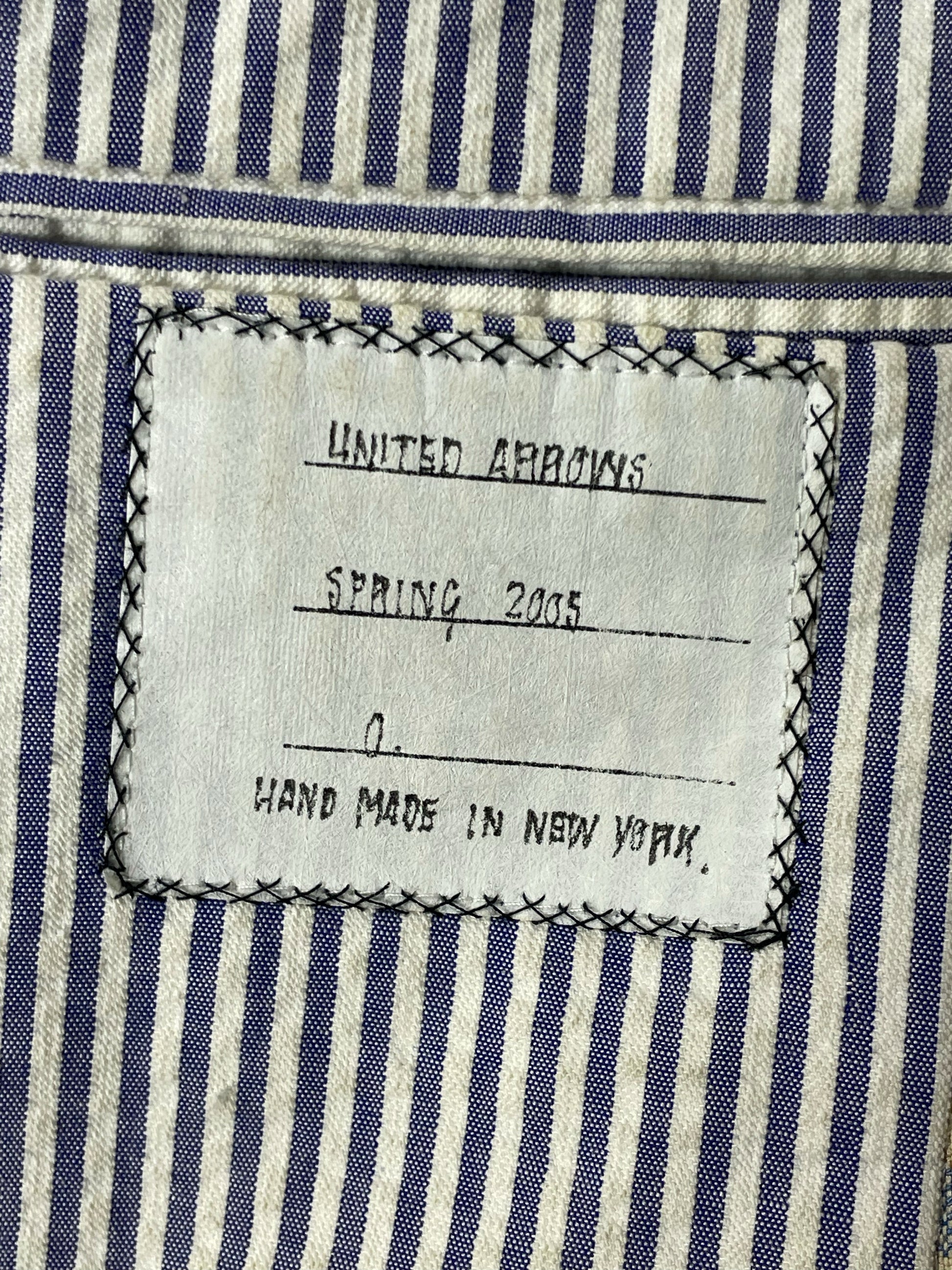 Blue seersucker striped lining of Thom Browne plaid wool sport coat