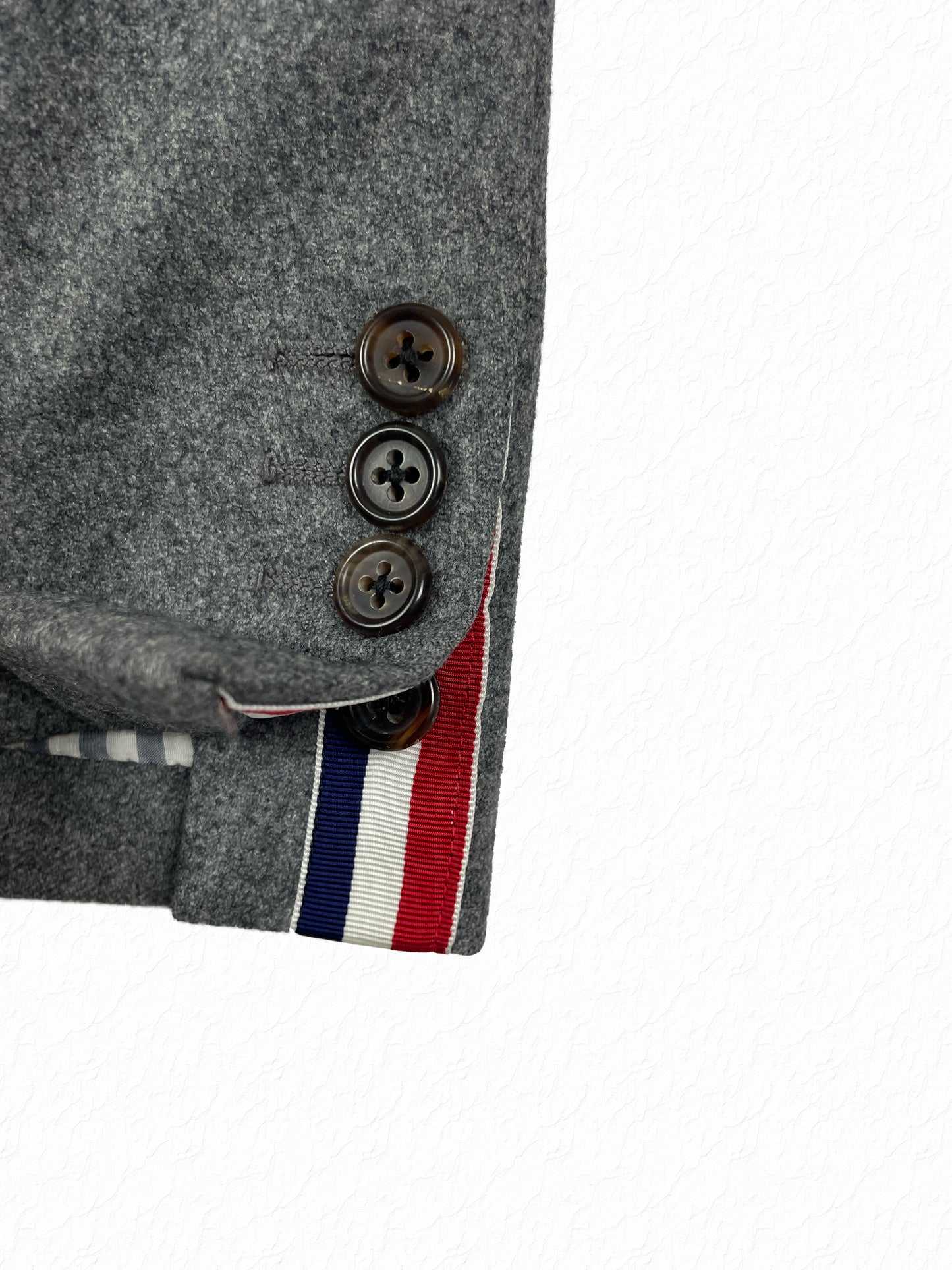 Thom Browne wool blazer with RWB grosgrain trim and horn buttons at cuff