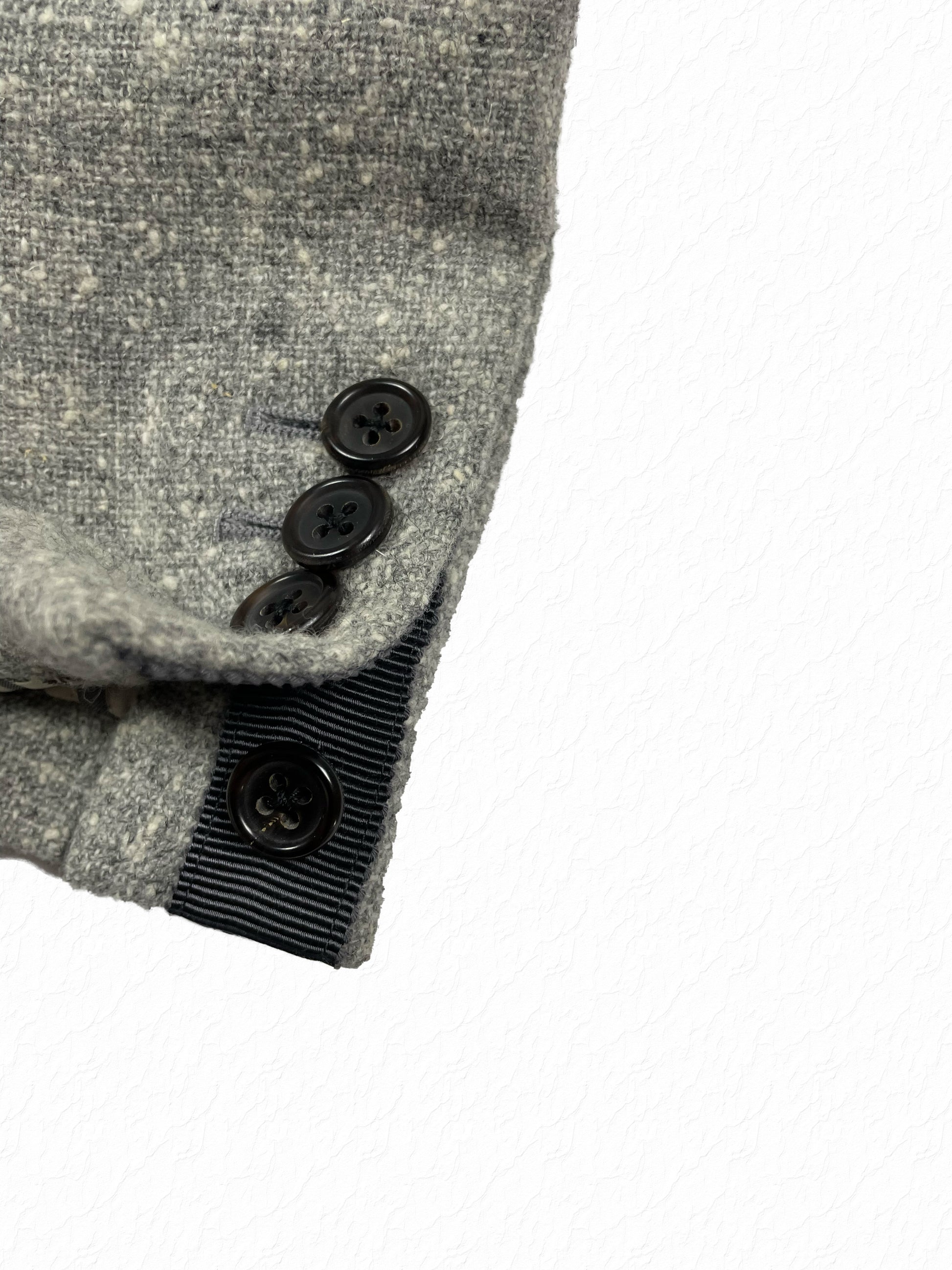 Grosgrain trimmed sleeve buttons on Thom Browne tweed jacket