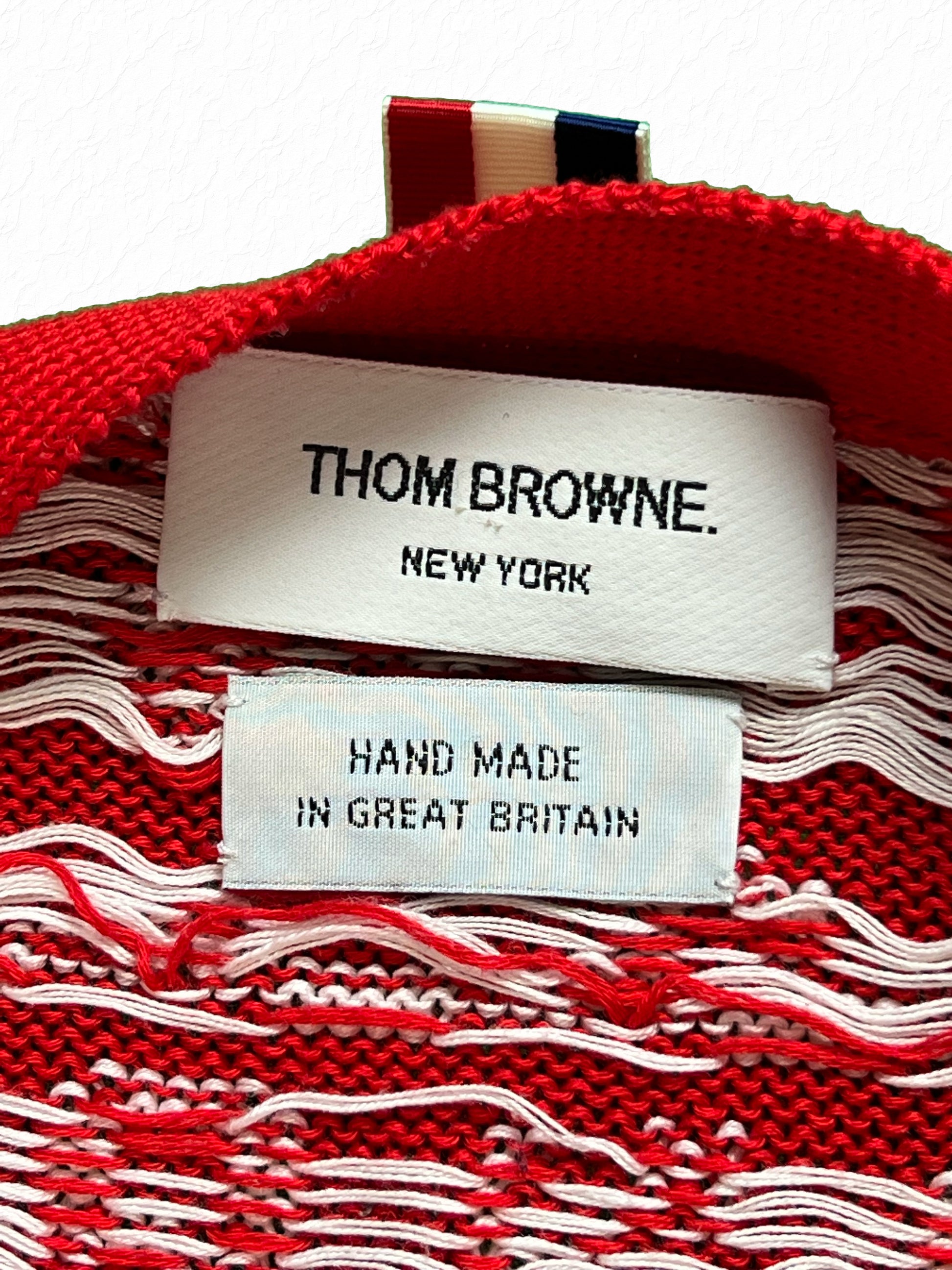 Red knit Thom Browne cardigan with rampant lion and nautical wave pattern