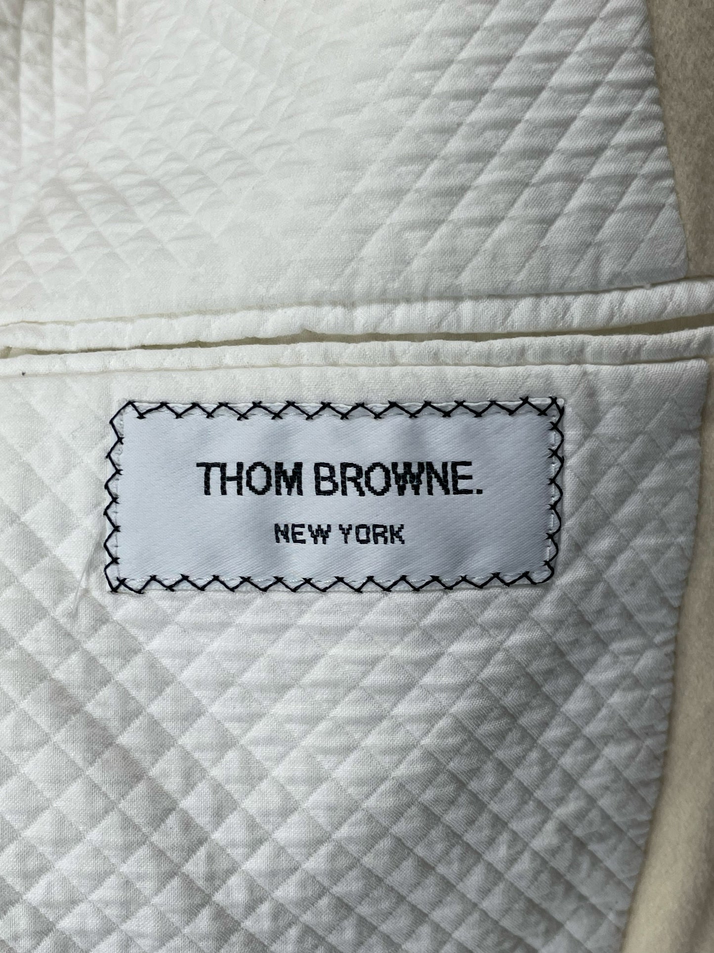 Thom Browne New York woven label stitched into quilted cotton interior