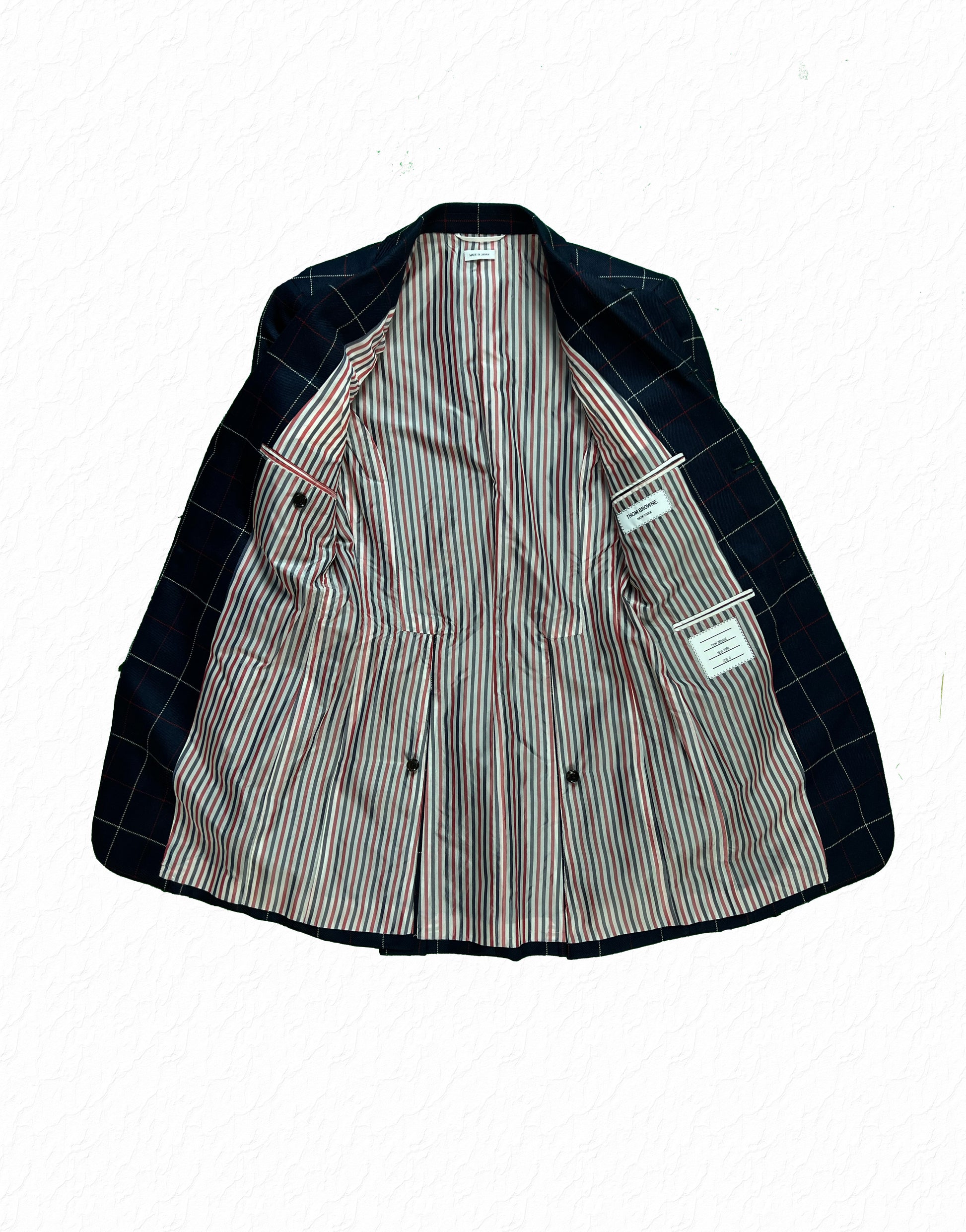 Square shoulder Thom Browne wool flannel sport coat in navy with red overcheck