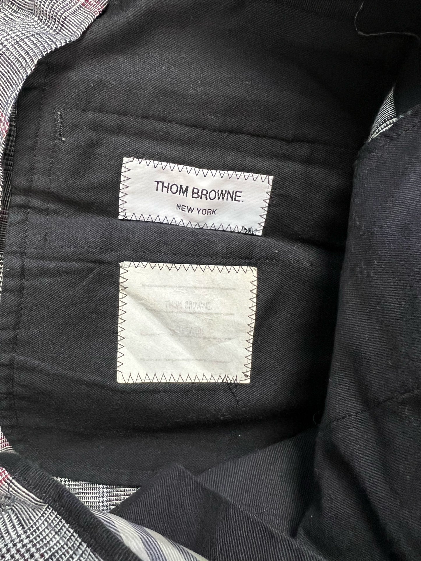 Prince of Wales check pattern Thom Browne trousers with striped waistband lining