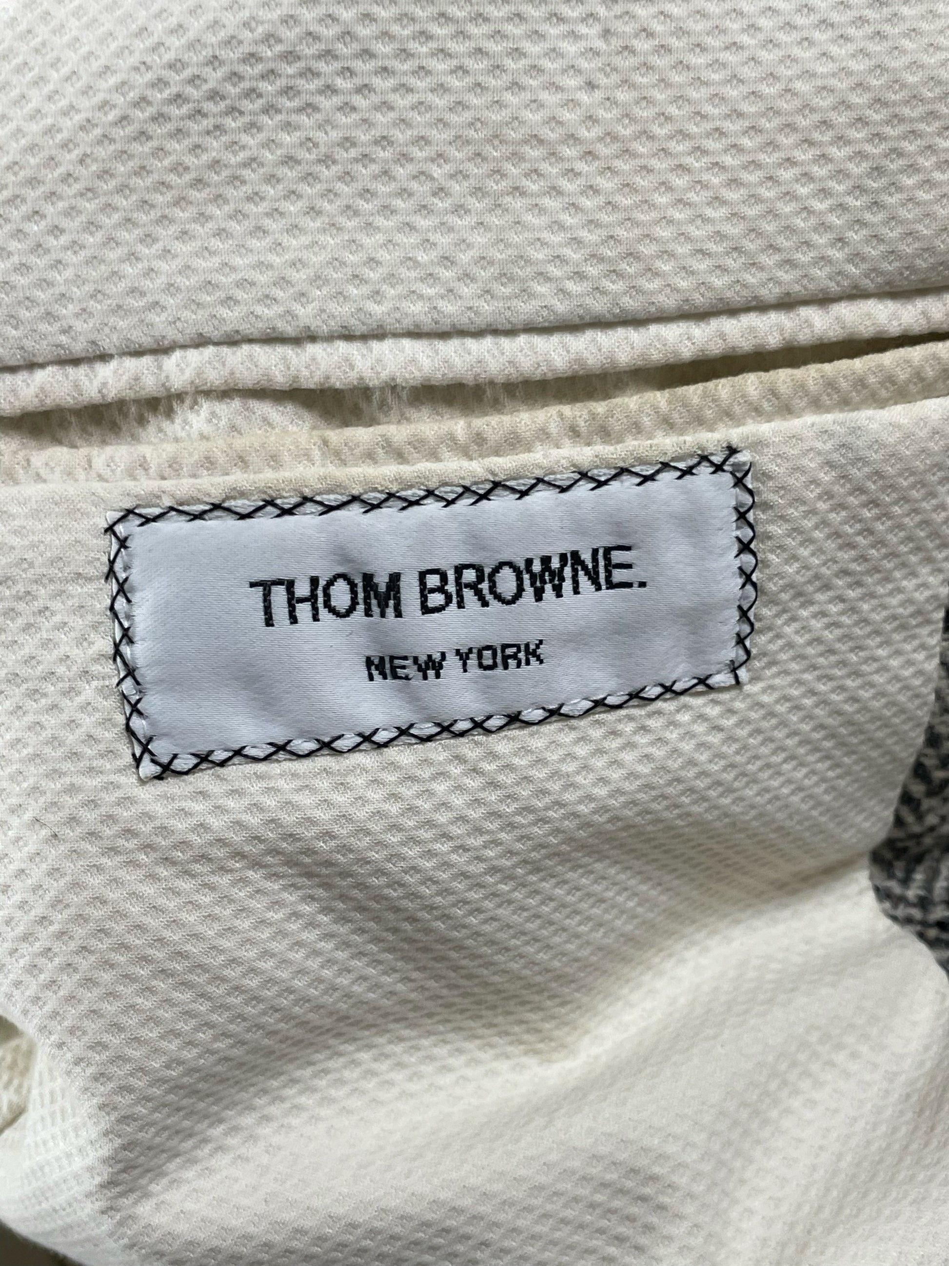 Thom Browne New York woven label on herringbone tweed blazer