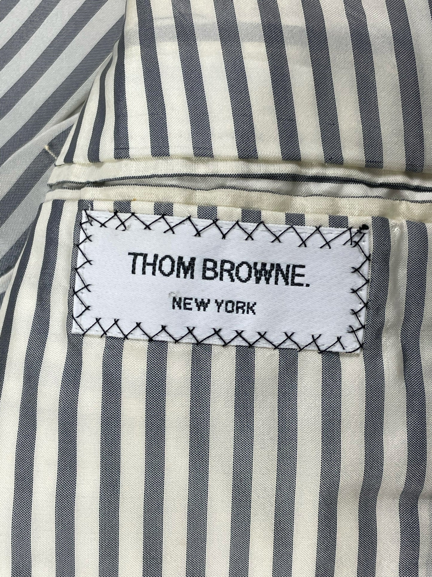 Signature gray and white striped lining in Thom Browne blazer