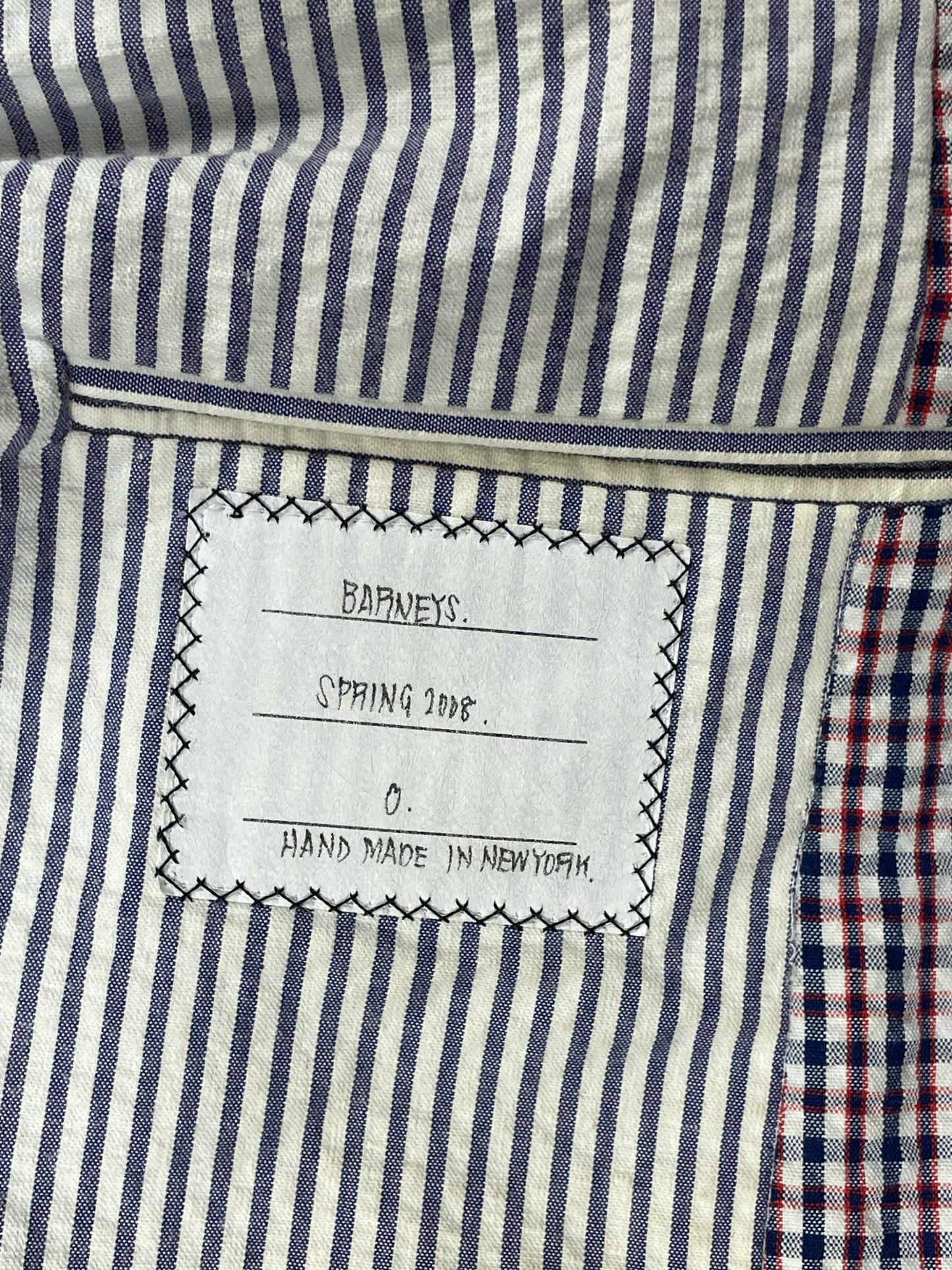 Blue and white striped lining inside Thom Browne archival gingham blazer