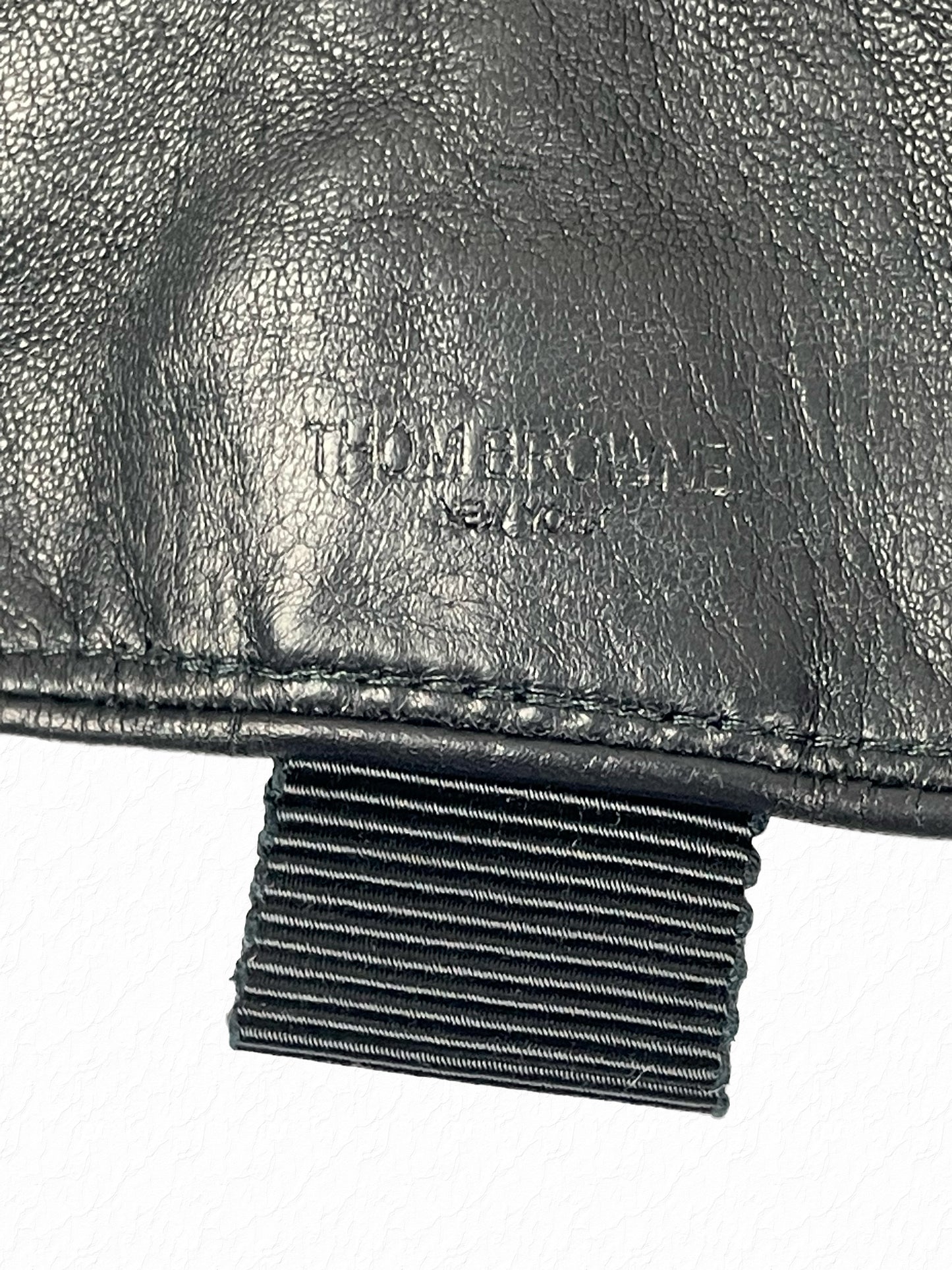 Grosgrain tab and smooth black calf leather on Thom Browne gloves