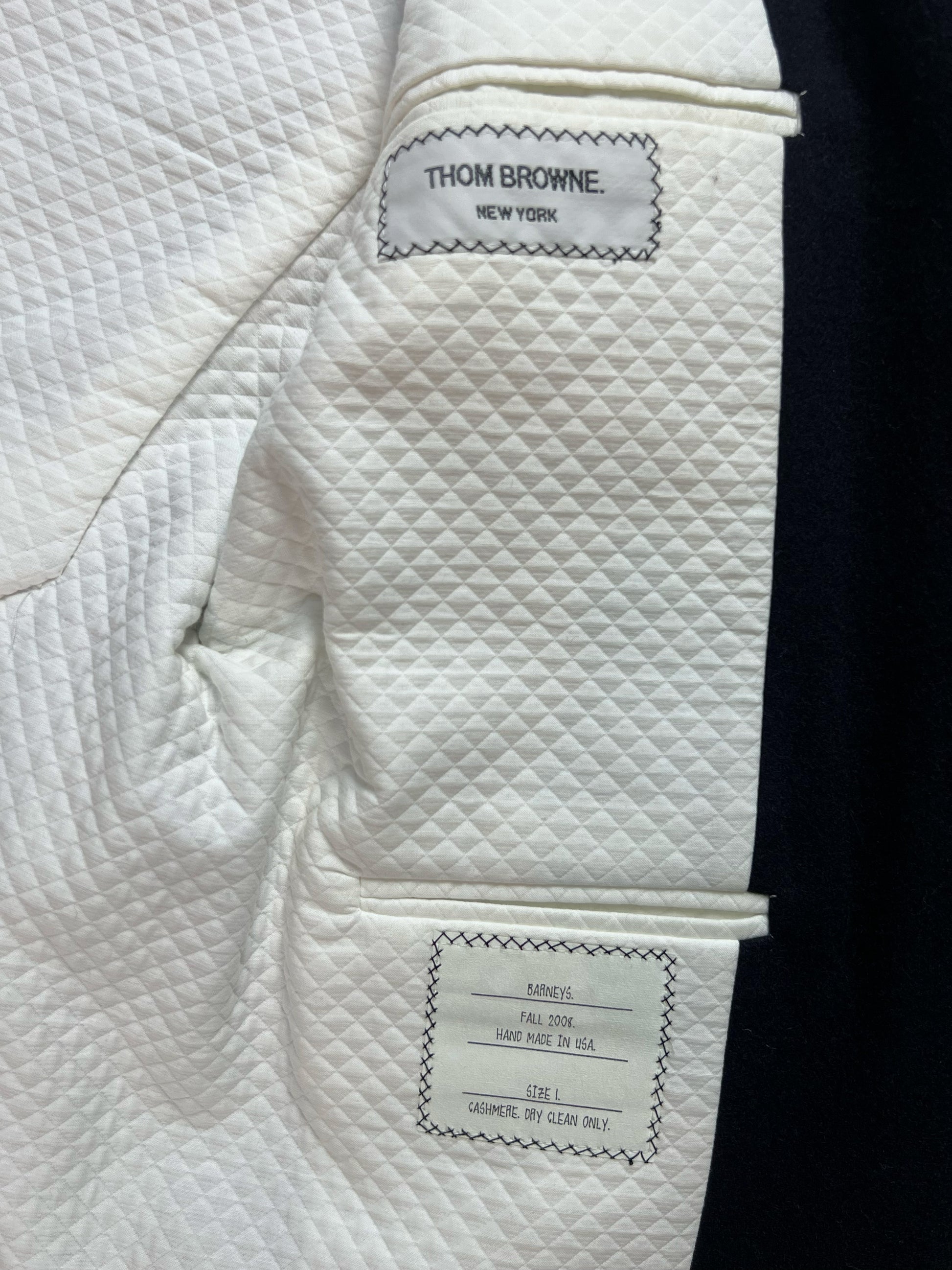 Quilted ivory lining inside Thom Browne cashmere blazer with hand stitched label