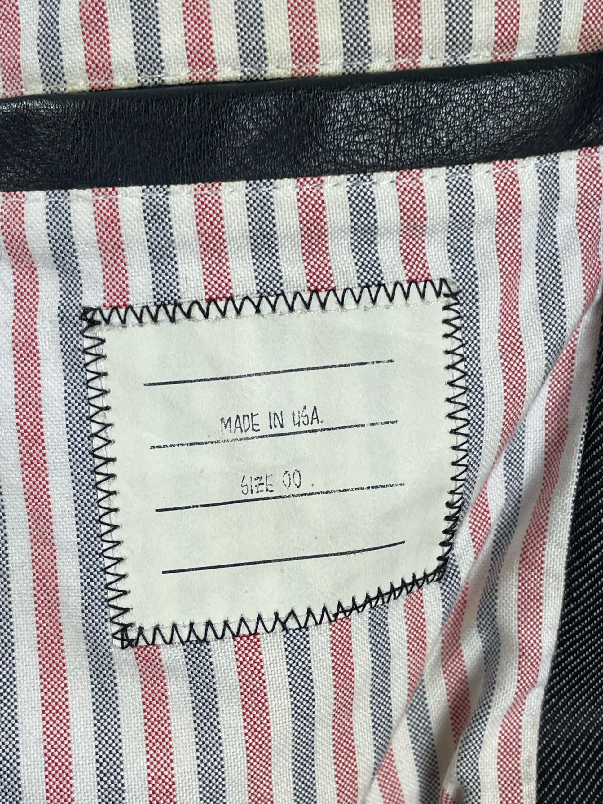 RWB tricolor striped interior lining on Thom Browne denim jacket