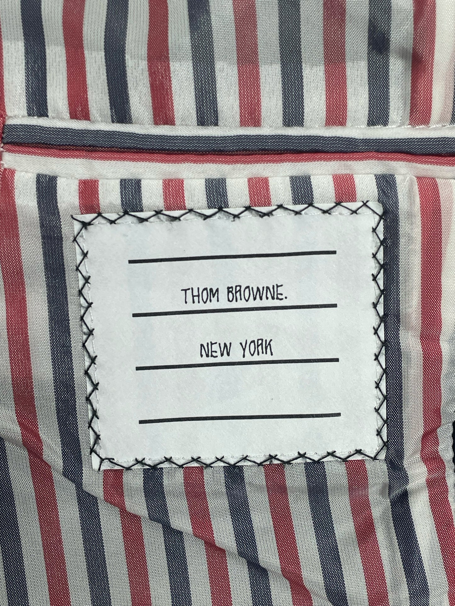 Anchor button closure on Thom Browne RWB sport coat