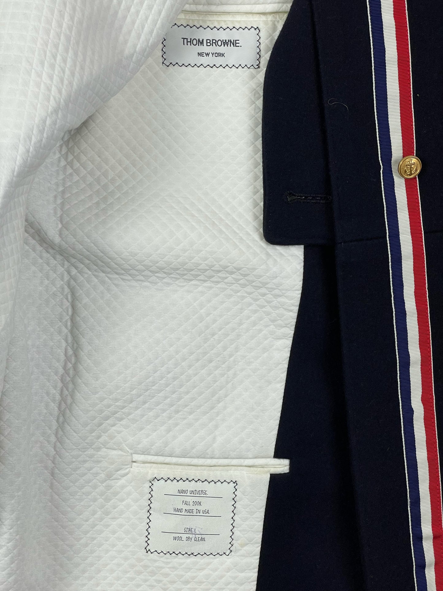 Quilted white lining inside Thom Browne Fall 2008 navy wool overcoat