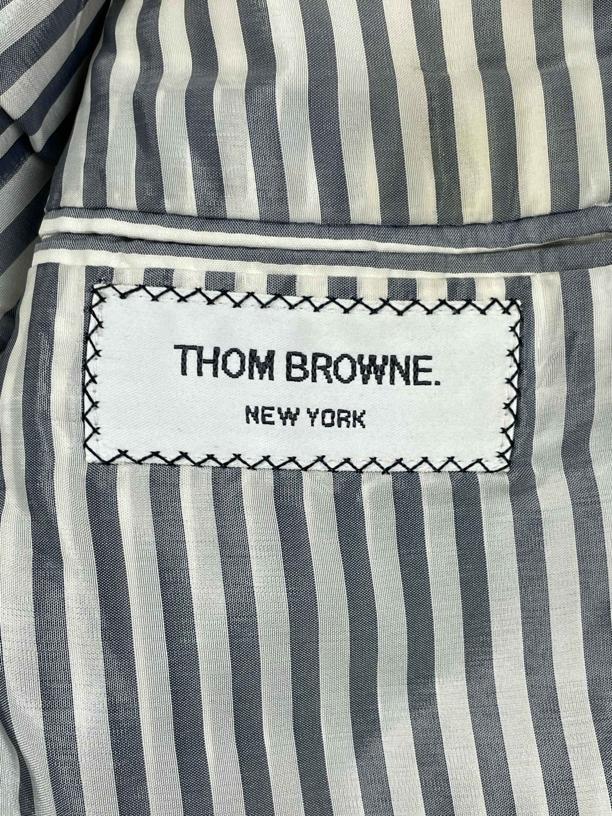 Thom Browne New York label on grey and white striped silk lining