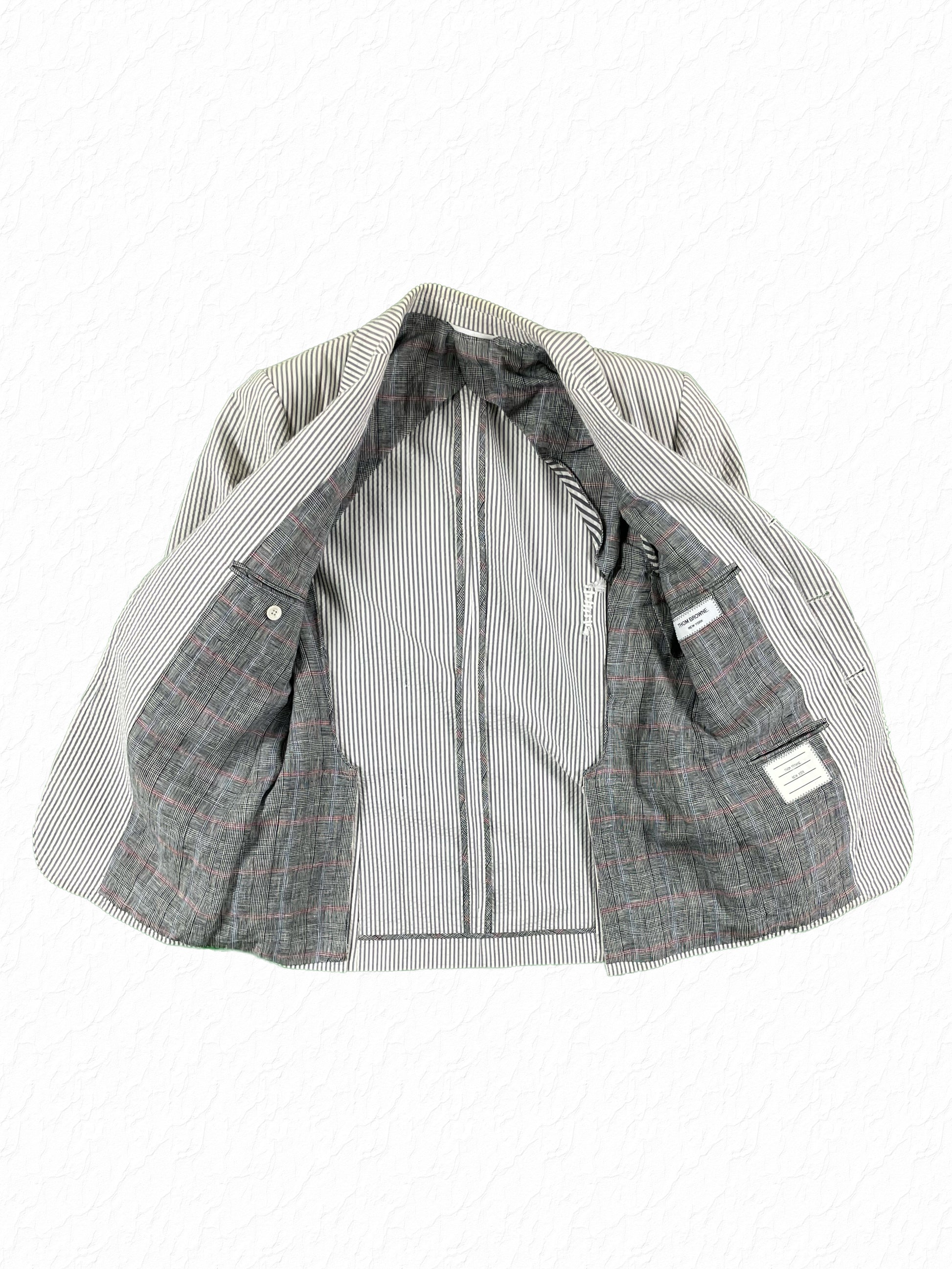 Prince of Wales check lining on Thom Browne seersucker blazer
