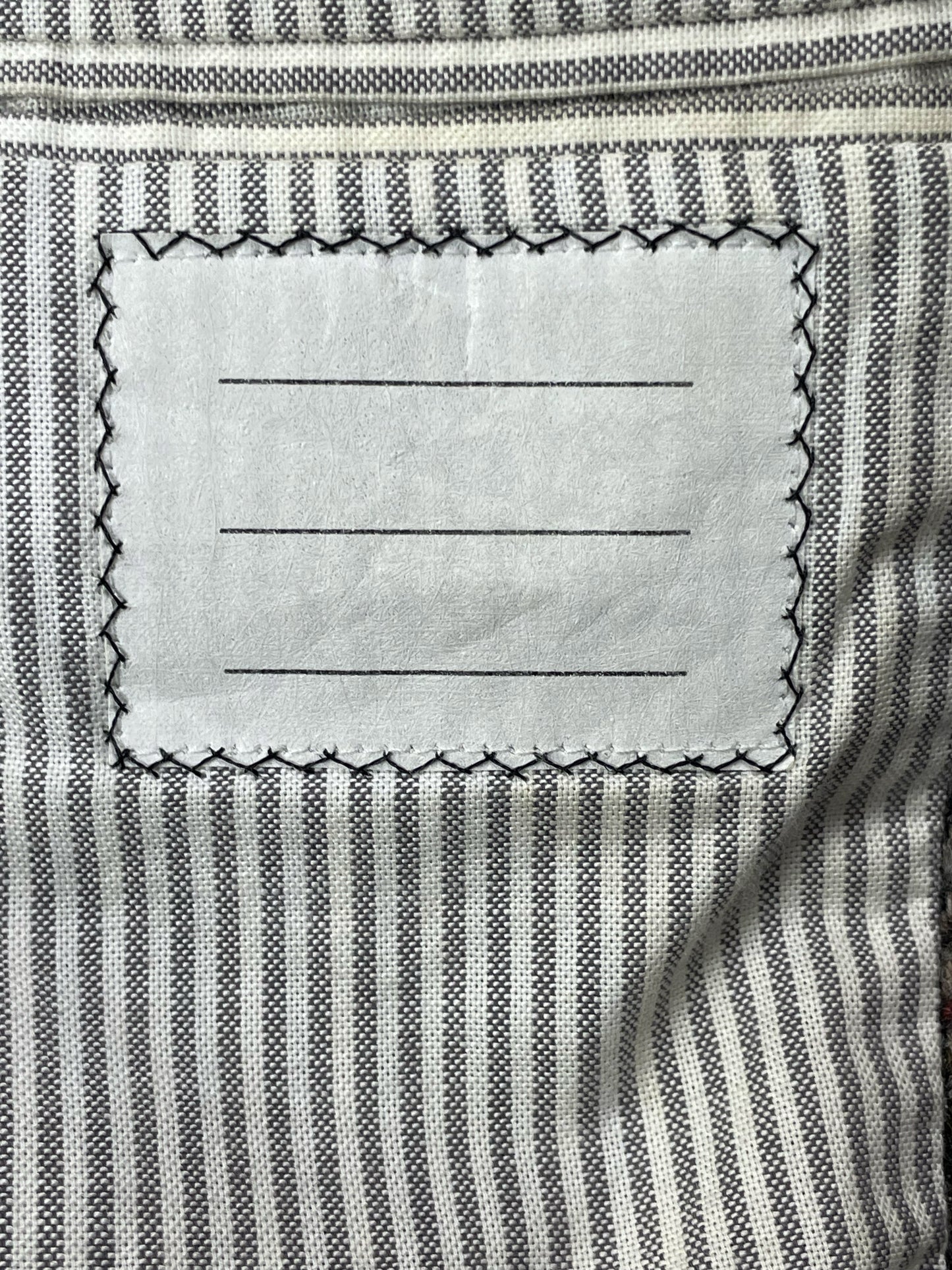 Striped grosgrain lining inside Thom Browne tweed sport coat