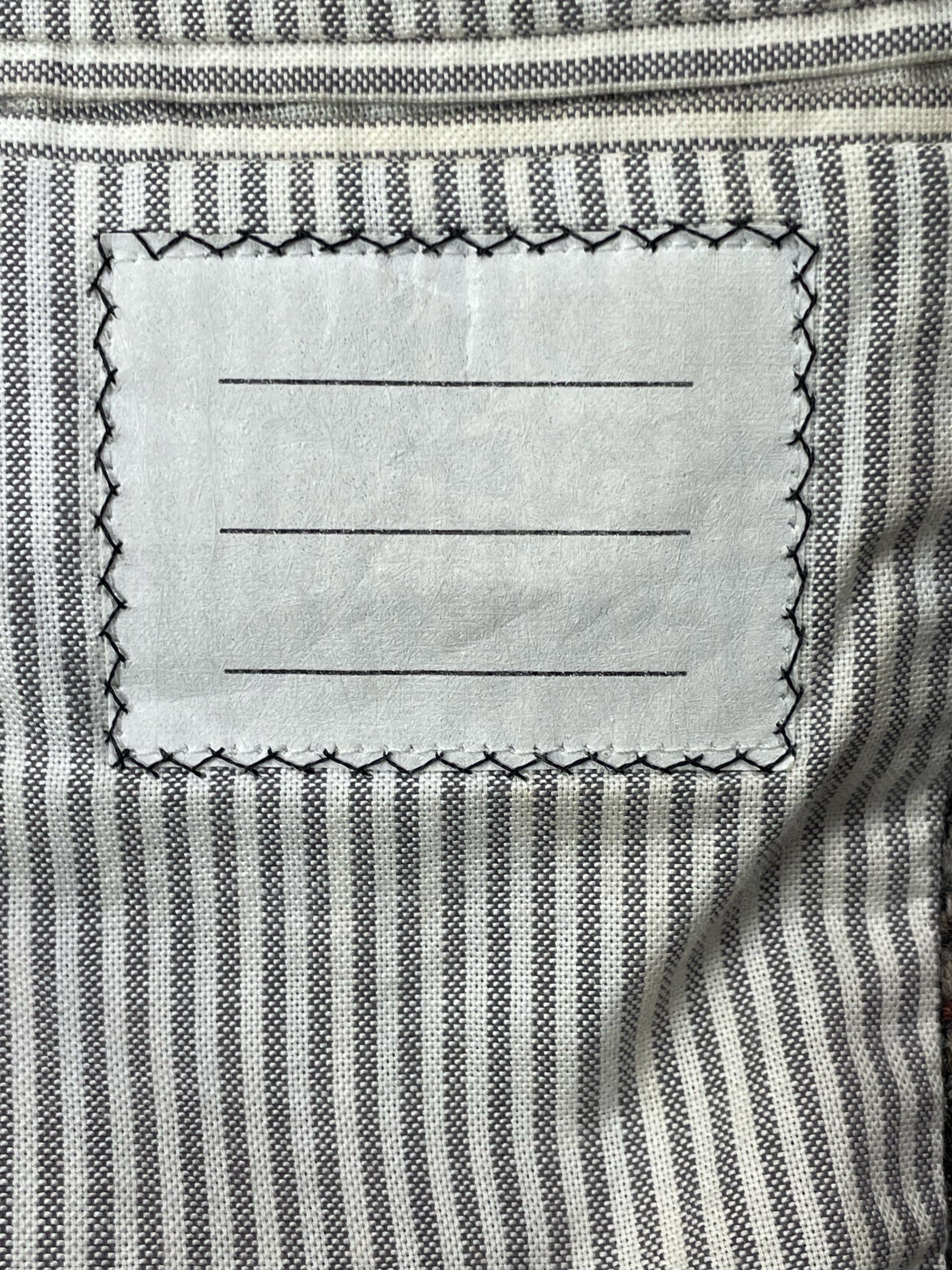 Striped grosgrain lining inside Thom Browne tweed sport coat