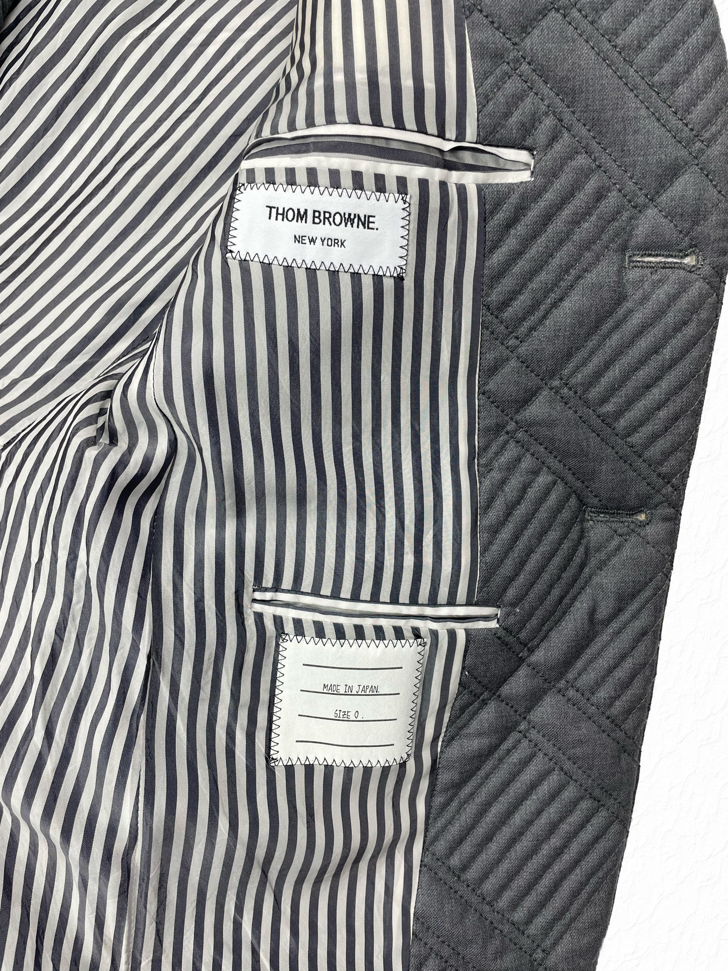 Quilted grey wool cashmere Thom Browne blazer with center vent