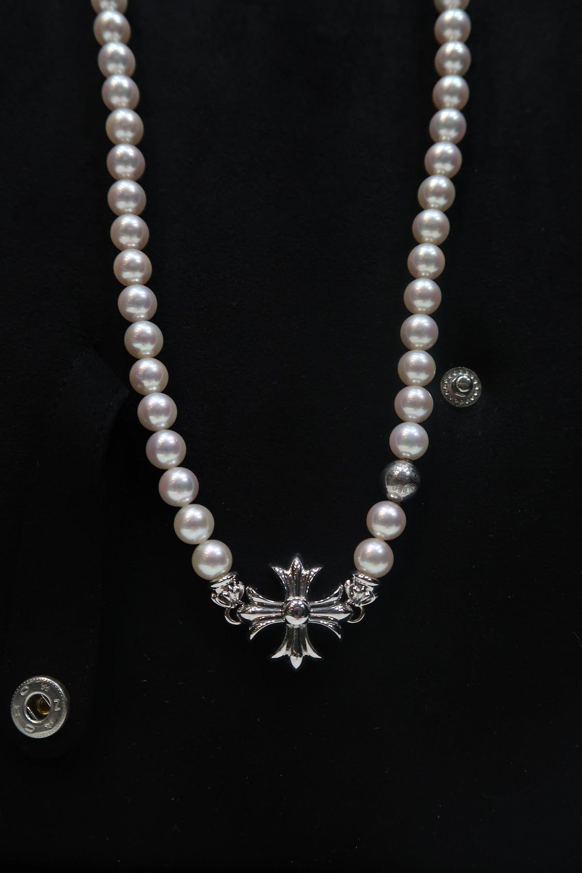 Chrome Hearts cross on a pearl necklace