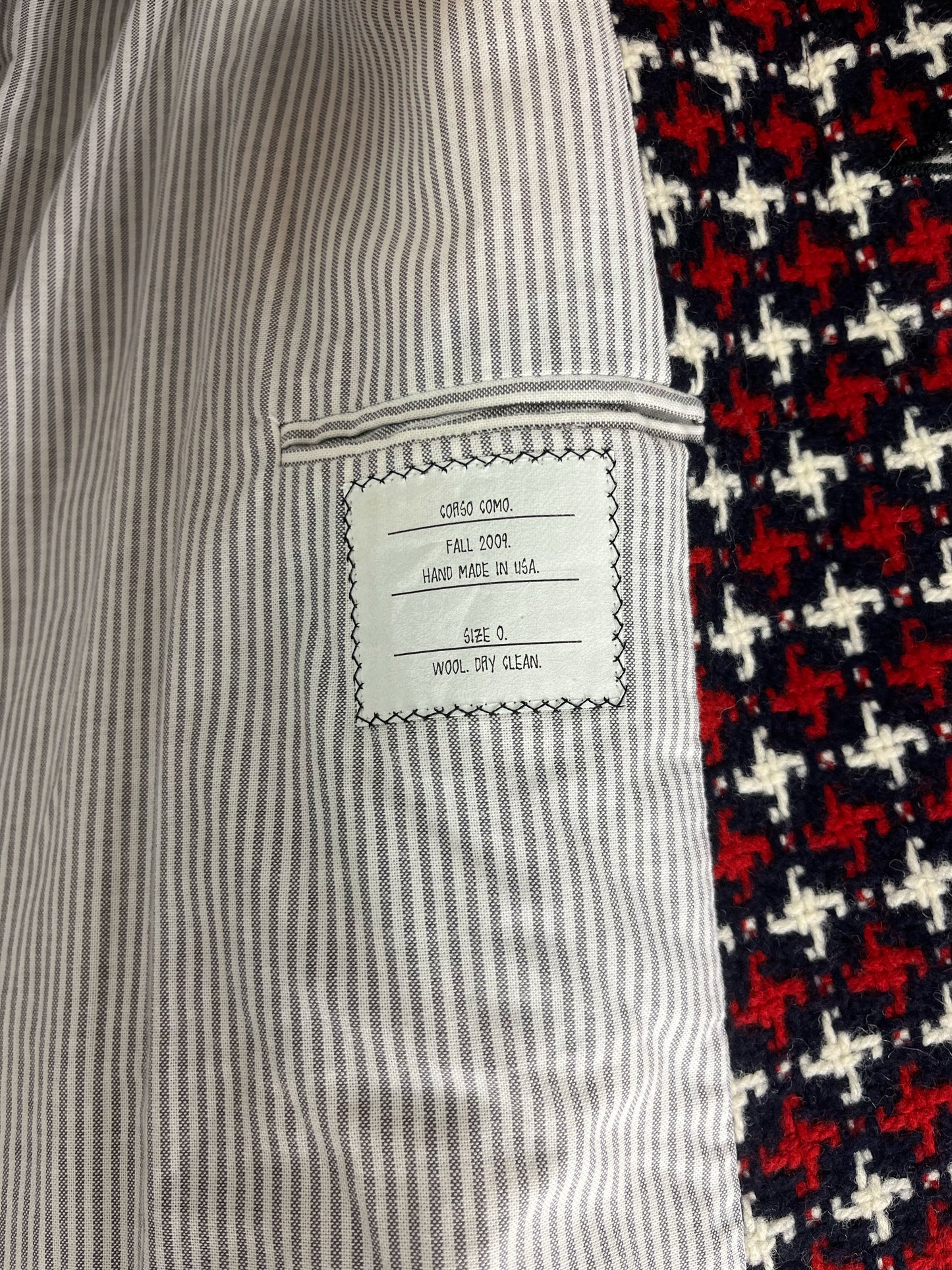 Epaulette shoulders and buttoned cuffs on Thom Browne RWB wool coat