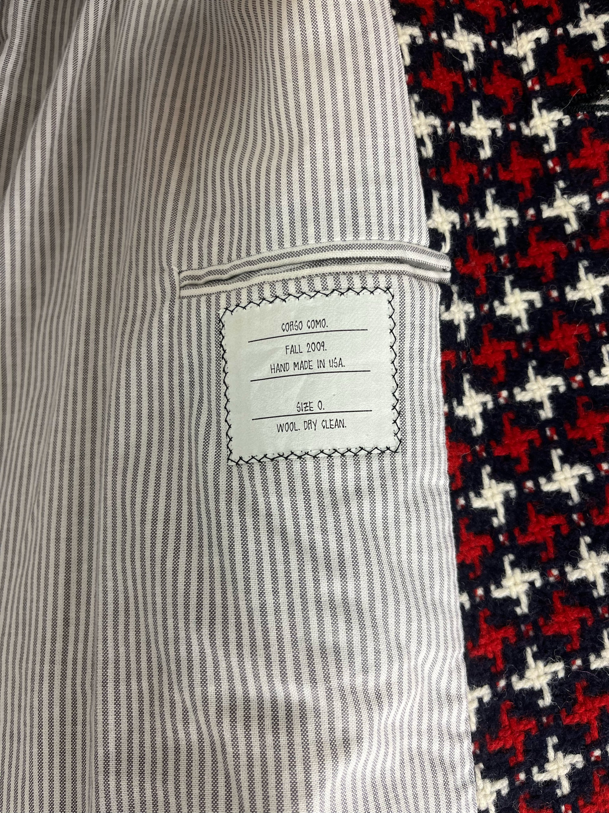 Epaulette shoulders and buttoned cuffs on Thom Browne RWB wool coat