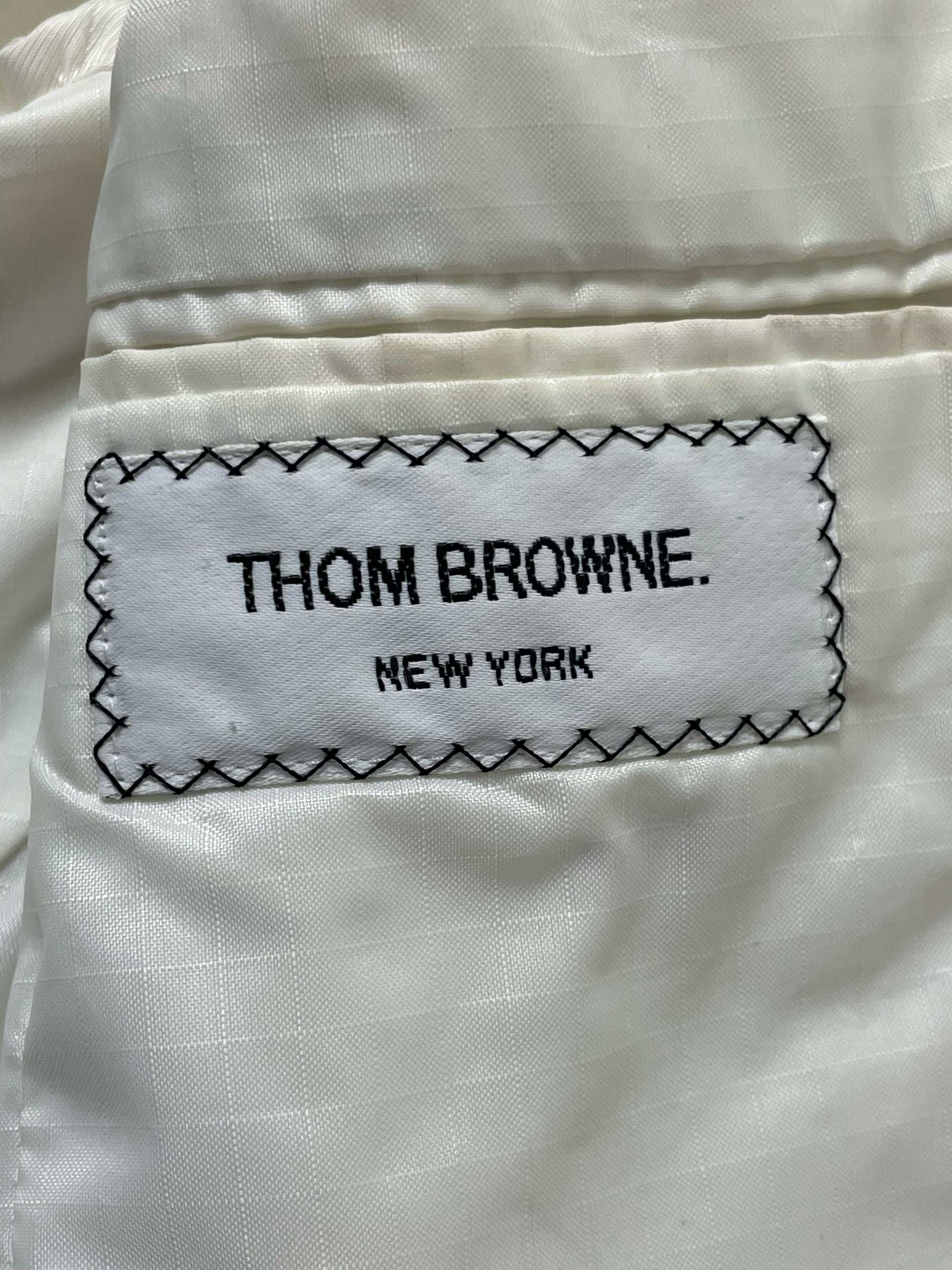 Signature tricolor RWB grosgrain accent on Thom Browne white mesh blazer
