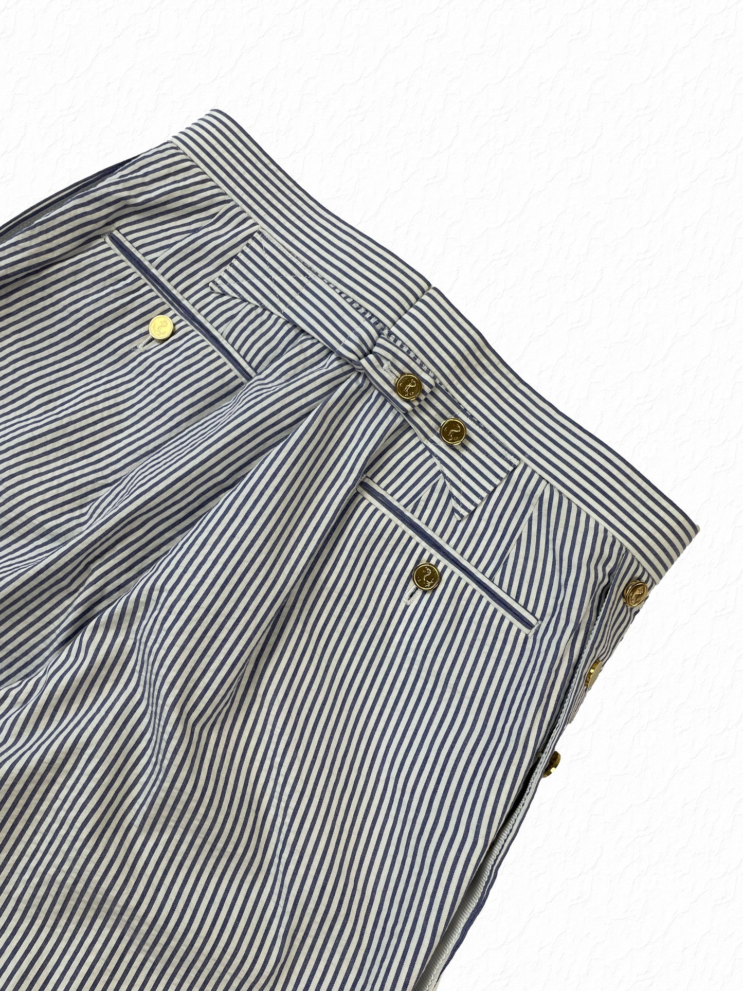 Welt pocket with gold anchor buttons on Thom Browne seersucker trousers