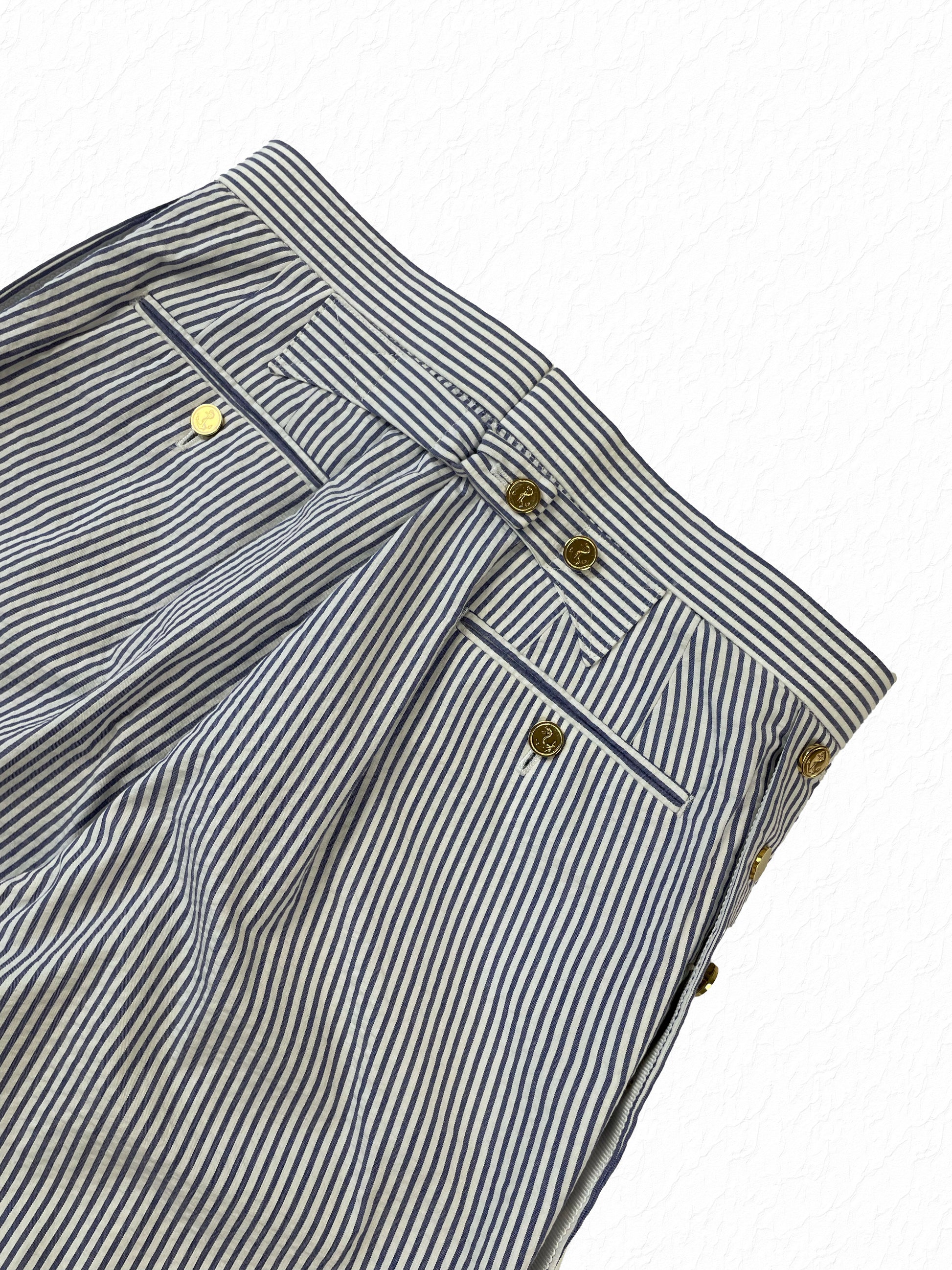 Welt pocket with gold anchor buttons on Thom Browne seersucker trousers